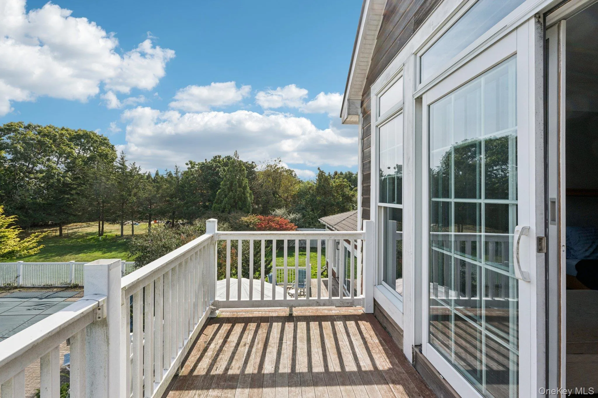 The primary bedroom, on the second level, opens to a private balcony offering sweeping views of the property’s expansive yard. The primary bedroom, on the second level, opens to a private balcony offering sweeping views of the property’s expansive yard.