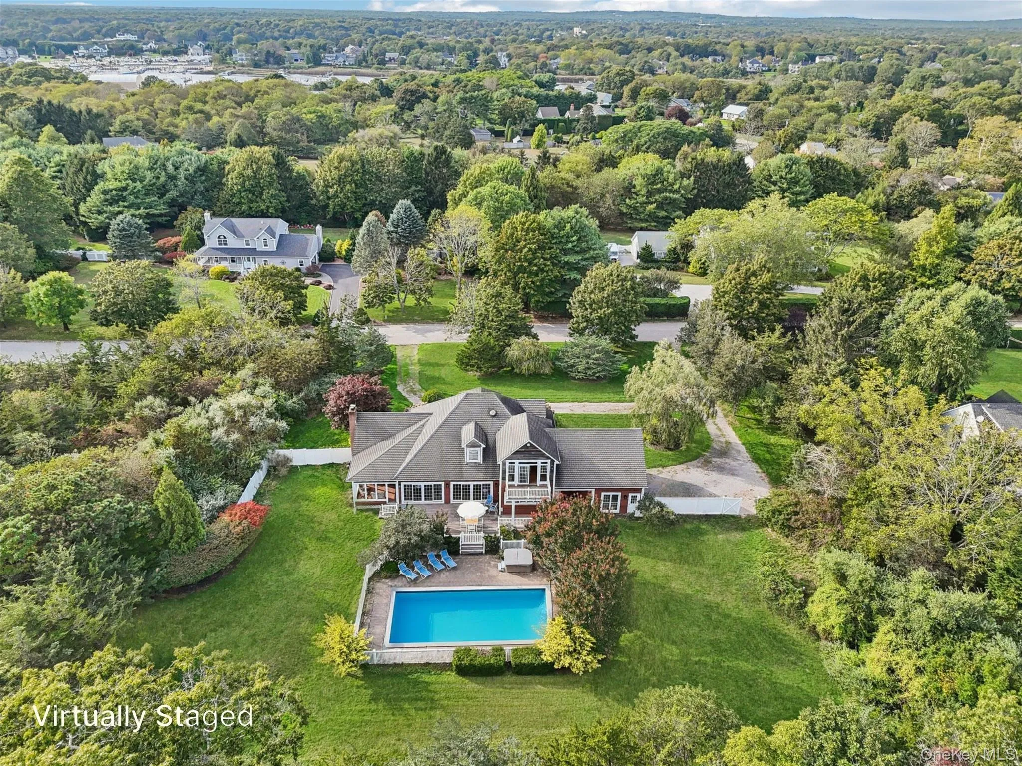A picturesque view showcasing the swimming pool, sunlit patio, and hot tub, all set within a private fenced backyard and complemented by a balcony overlooking the serene outdoor oasis. Virtually Staged to show open pool. A picturesque view showcasing the swimming pool, sunlit patio, and hot tub, all set within a private fenced backyard and complemented by a balcony overlooking the serene outdoor oasis. Virtually Staged to show open pool.