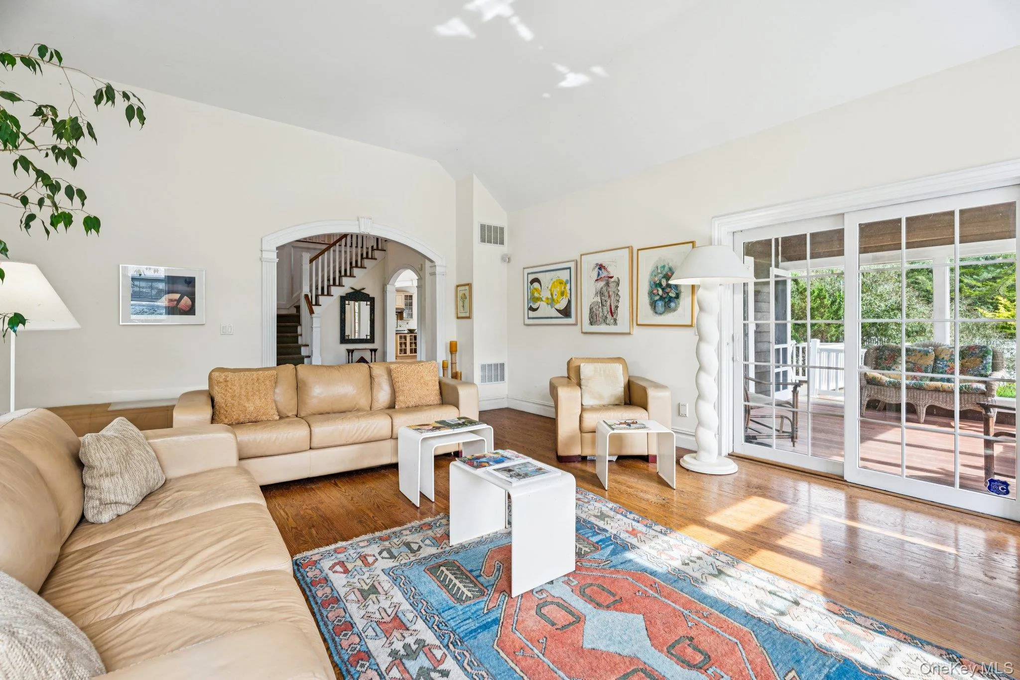 Inviting living area showcasing vaulted ceilings, rich oak hardwood floors, and a charming wood-burning fireplace. Inviting living area showcasing vaulted ceilings, rich oak hardwood floors, and a charming wood-burning fireplace.