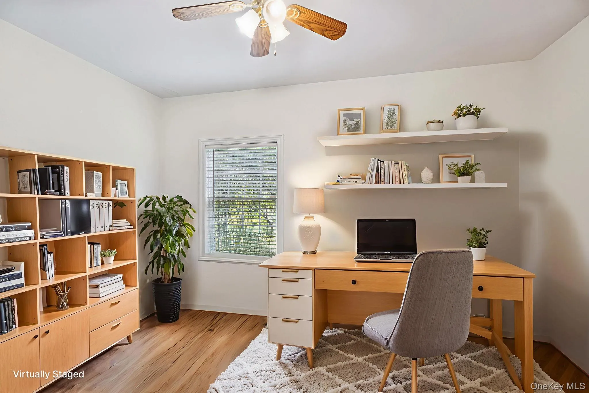 Bedroom / Office space with light wood-style flooring and a ceiling fan. Bedroom / Office space with light wood-style flooring and a ceiling fan.
