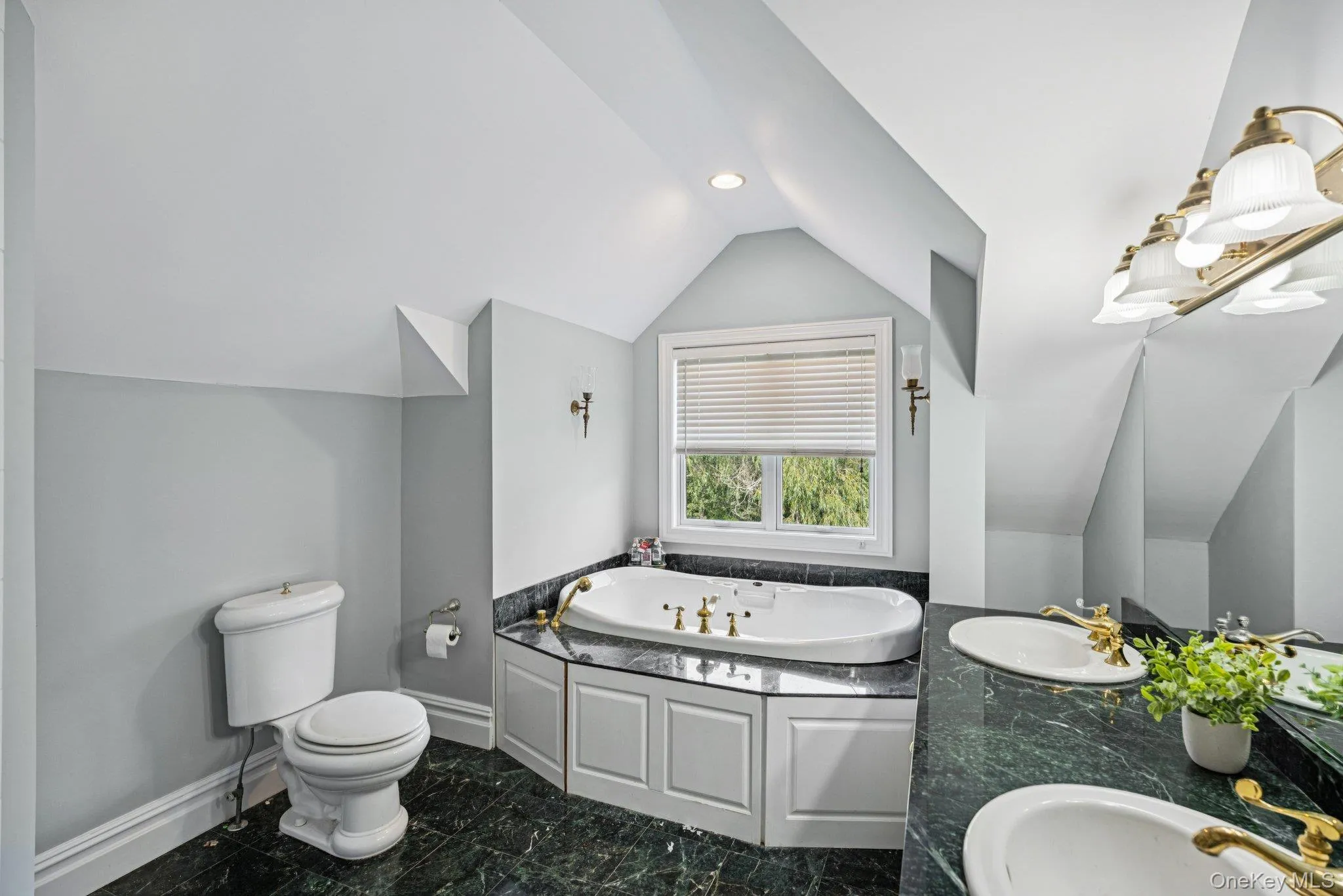 Luxurious primary bath showcasing a whirlpool jetted tub, ambient recessed lighting, a double vanity, and an e-steam shower for a spa-like experience. Luxurious primary bath showcasing a whirlpool jetted tub, ambient recessed lighting, a double vanity, and an e-steam shower for a spa-like experience.