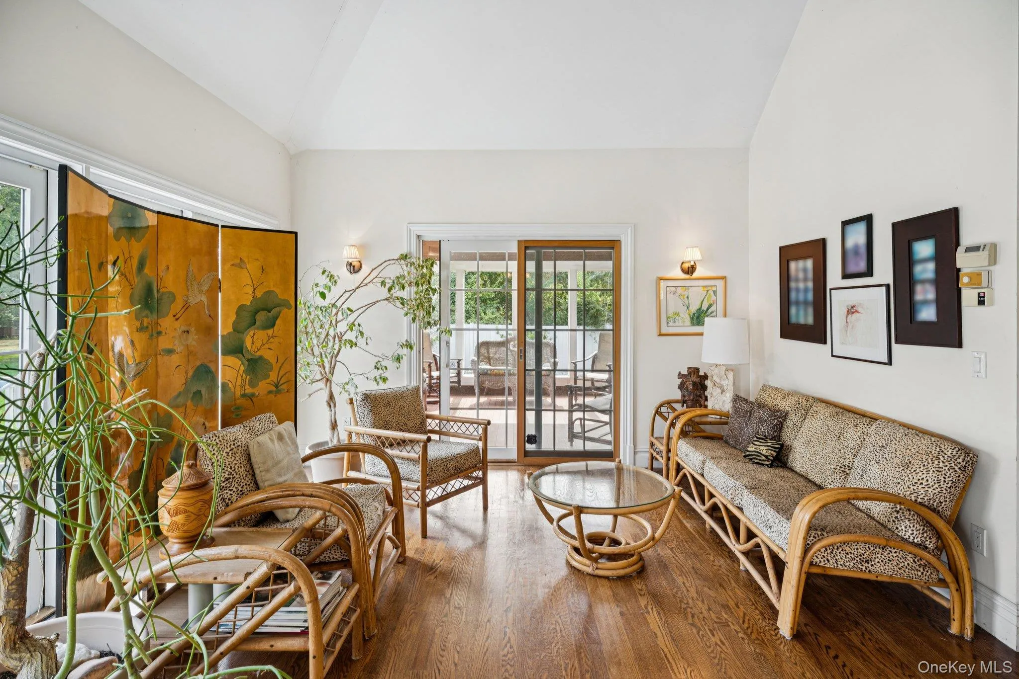 Inviting living area showcasing rich wood-finished floors and a soaring cathedral ceiling. Inviting living area showcasing rich wood-finished floors and a soaring cathedral ceiling.