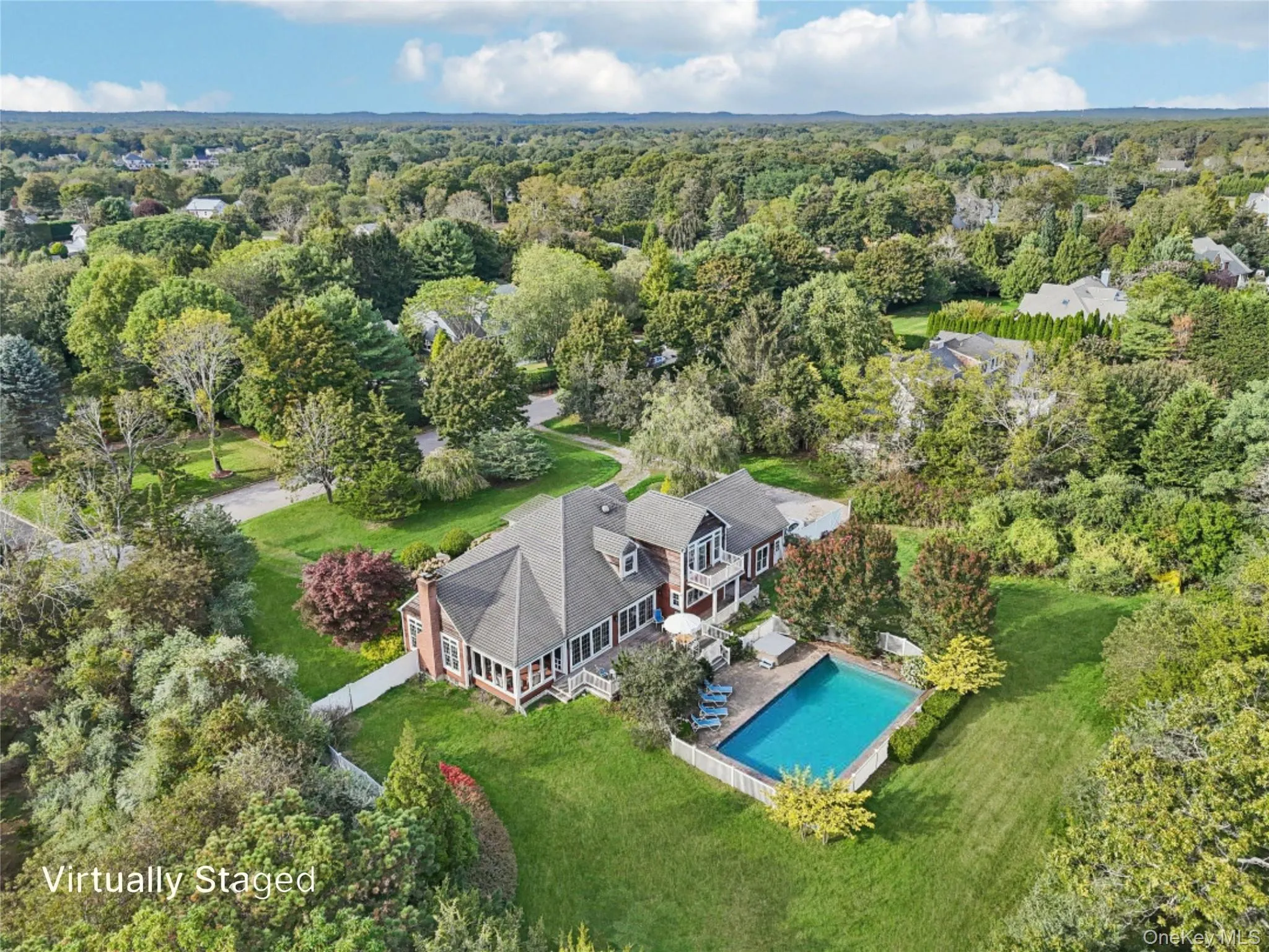 From the rear, the home reveals its inviting charm—complete with a fenced backyard, elegant chimney, and sunroom that seamlessly connects to the mahogany deck and poolside retreat. Virtually Staged to show open pool. From the rear, the home reveals its inviting charm—complete with a fenced backyard, elegant chimney, and sunroom that seamlessly connects to the mahogany deck and poolside retreat. Virtually Staged to show open pool.