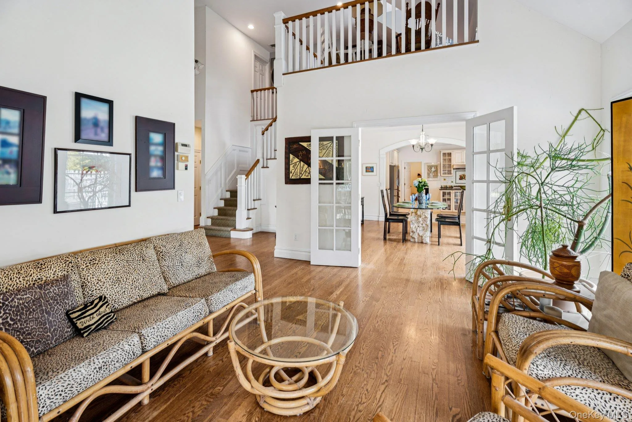 An expansive living area showcasing rich oak flooring and a dramatic cathedral ceiling that enhances the home’s refined character. An expansive living area showcasing rich oak flooring and a dramatic cathedral ceiling that enhances the home’s refined character.