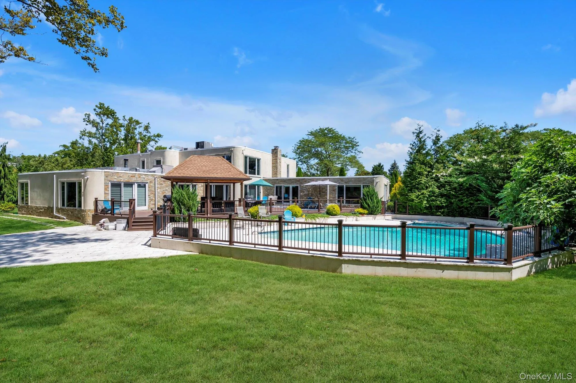 View of pool with a patio and a deck View of pool with a patio and a deck