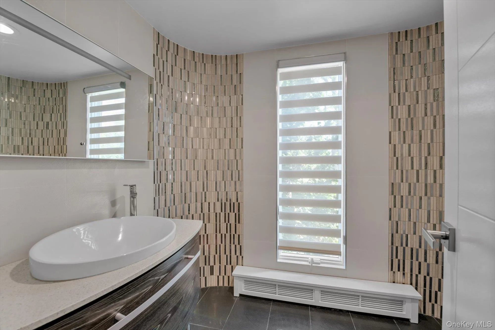 Powder Room featuring tile walls, tile patterned floors, and vanity Powder Room featuring tile walls, tile patterned floors, and vanity