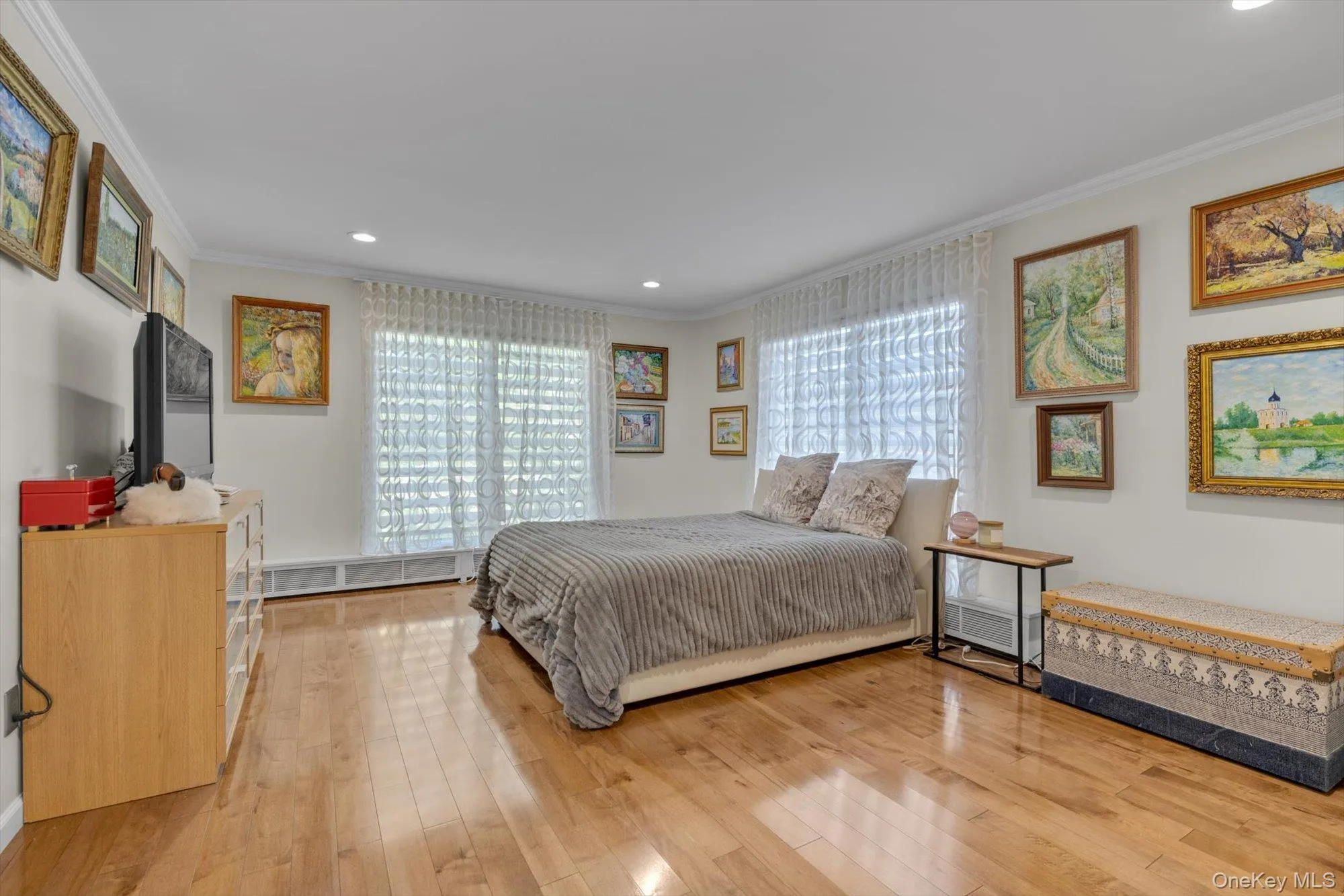 Bedroom with recessed lighting, light wood floors, and ornamental molding Bedroom with recessed lighting, light wood floors, and ornamental molding