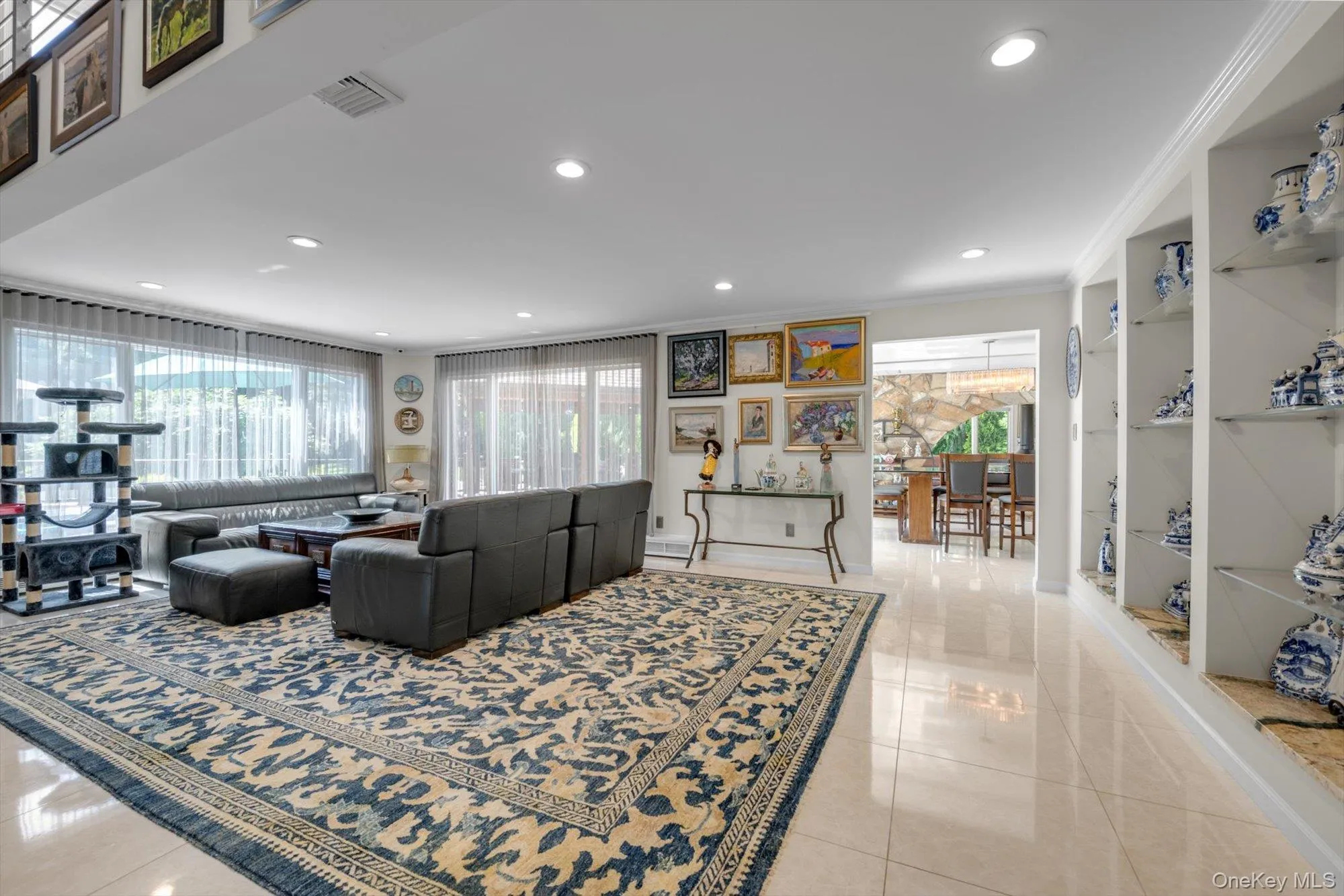Living Room with plenty of natural light, light tile patterned floors, recessed lighting, and crown molding Living Room with plenty of natural light, light tile patterned floors, recessed lighting, and crown molding