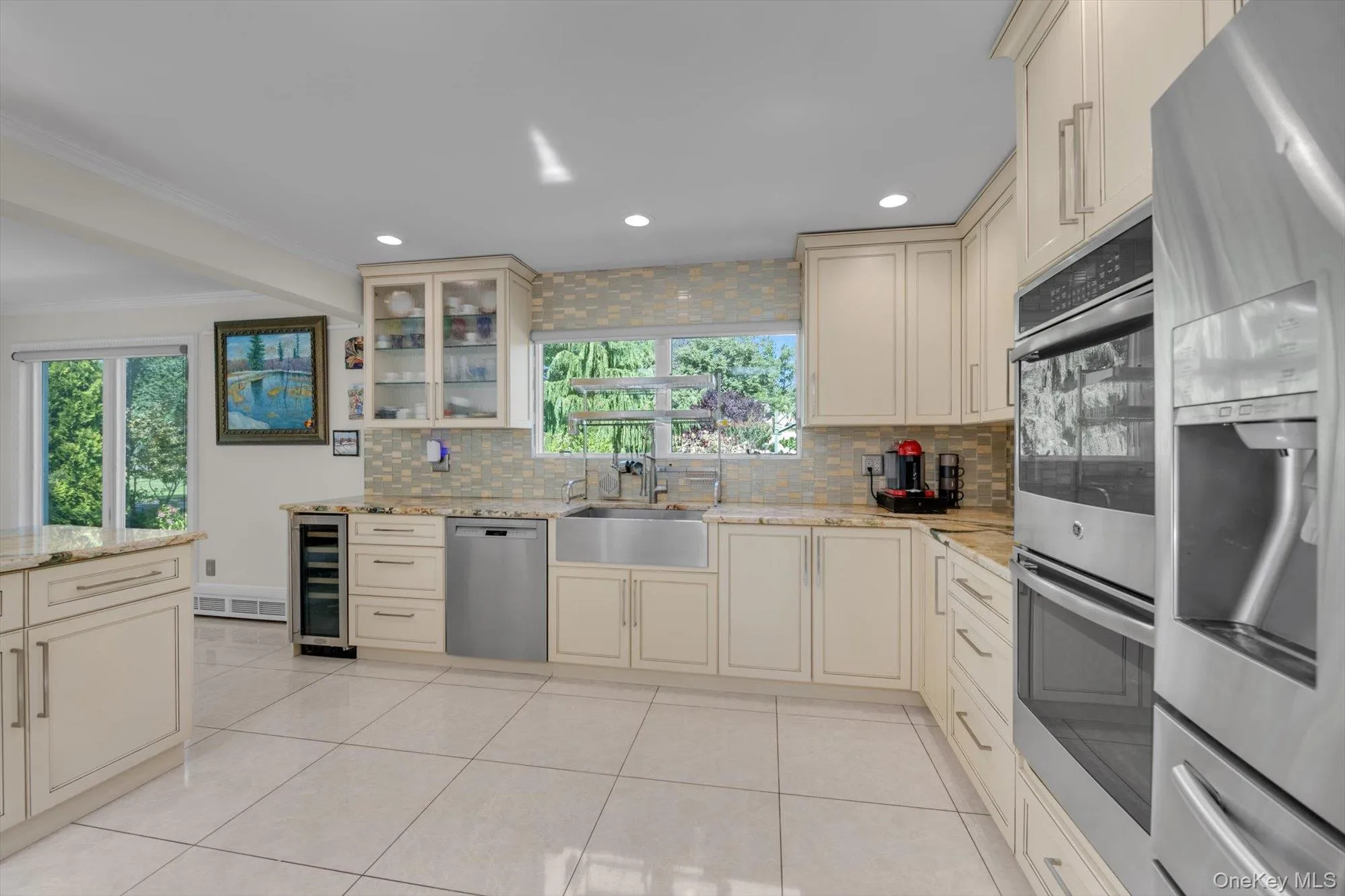 Kitchen with wood cabinets, tasteful backsplash, stainless steel appliances, light tile patterned floors, and recessed lighting Kitchen with wood cabinets, tasteful backsplash, stainless steel appliances, light tile patterned floors, and recessed lighting