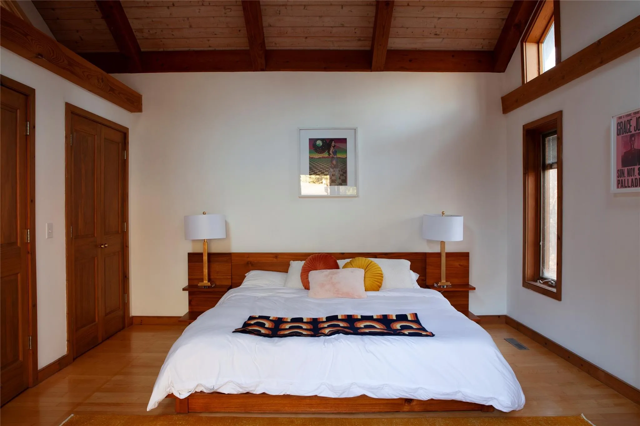 Bedroom featuring light wood finished floors and wooden ceiling Bedroom featuring light wood finished floors and wooden ceiling