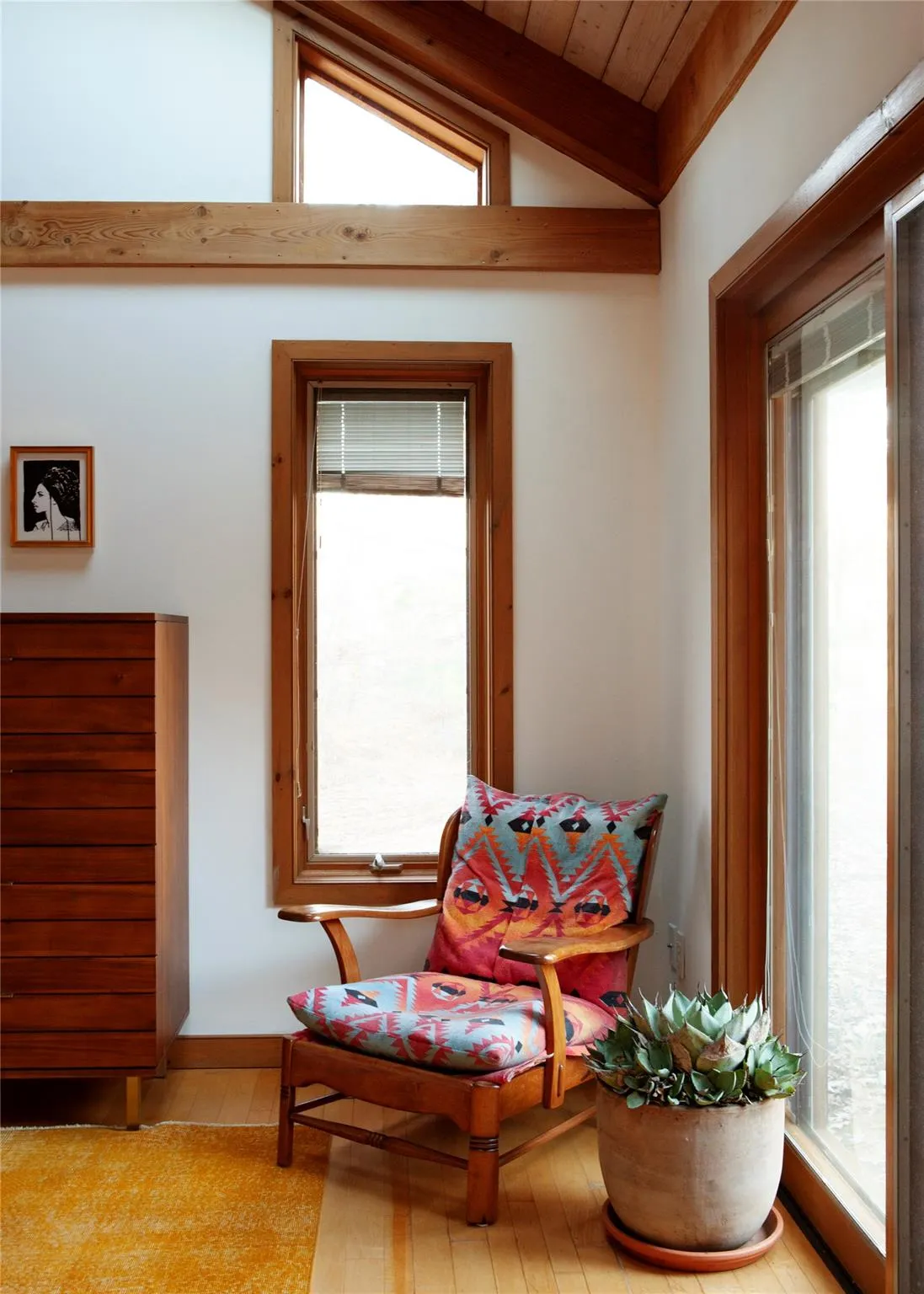 Sitting room featuring lofted ceiling, healthy amount of natural light, and wood finished floors Sitting room featuring lofted ceiling, healthy amount of natural light, and wood finished floors