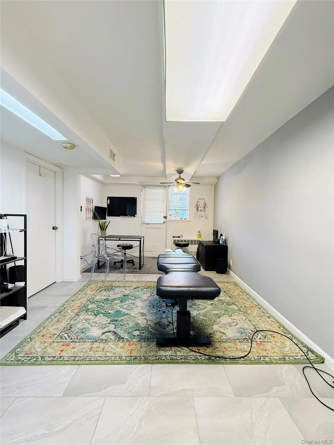 Rec room featuring a ceiling fan and baseboards Rec room featuring a ceiling fan and baseboards