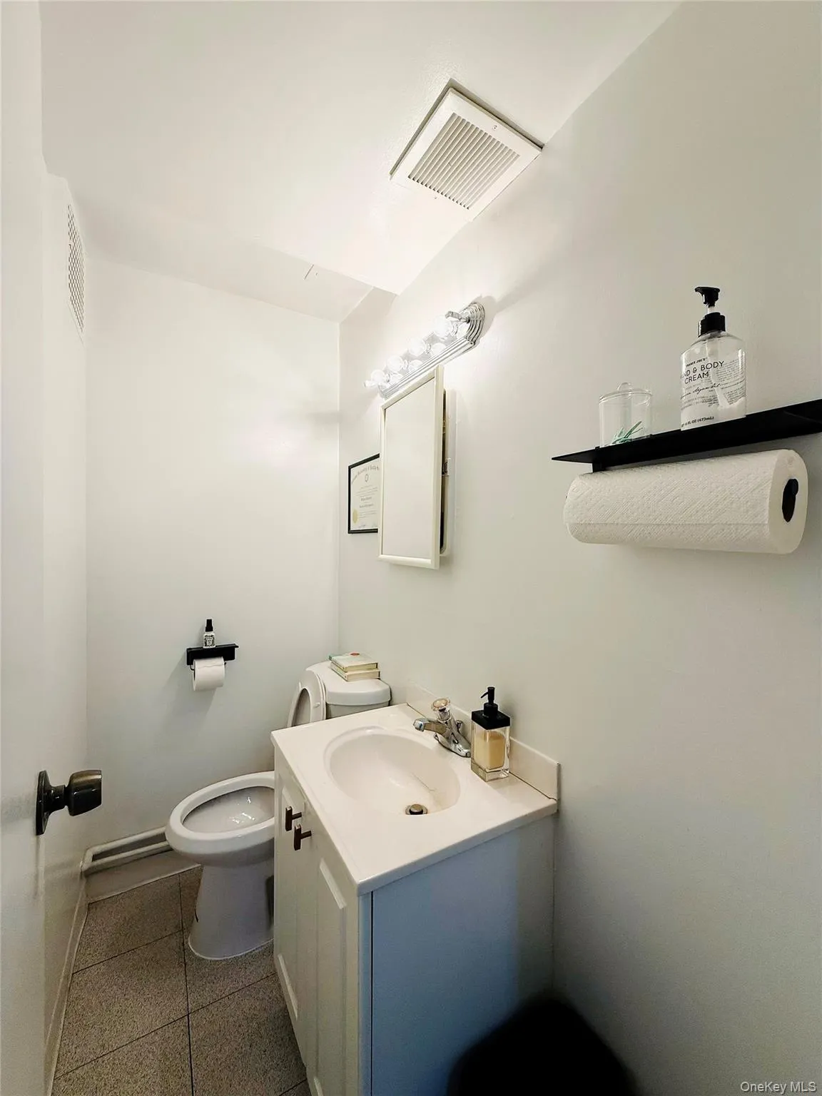 Half bathroom featuring vanity and toilet Half bathroom featuring vanity and toilet
