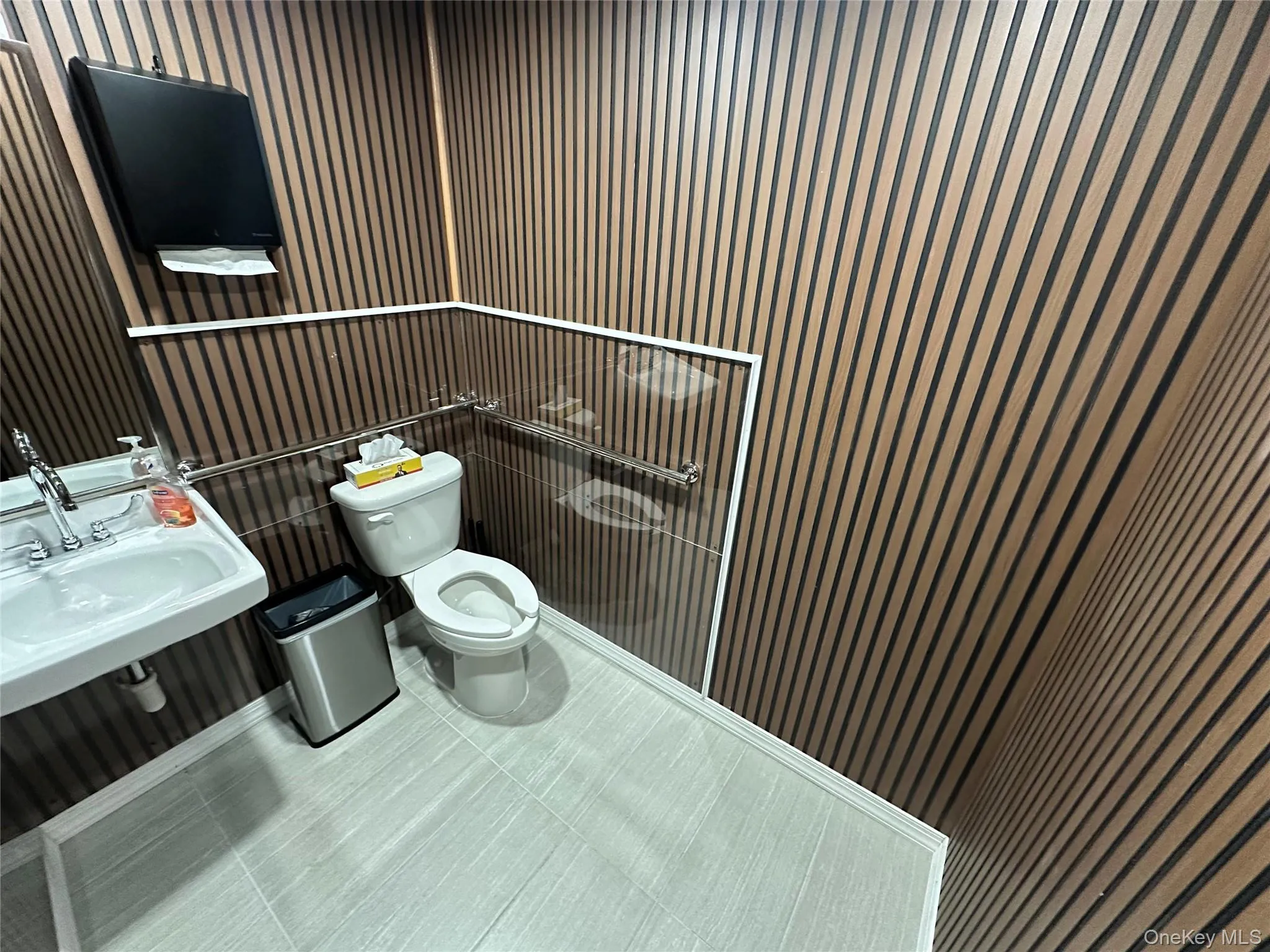 Half bath with toilet and tile patterned flooring Half bath with toilet and tile patterned flooring