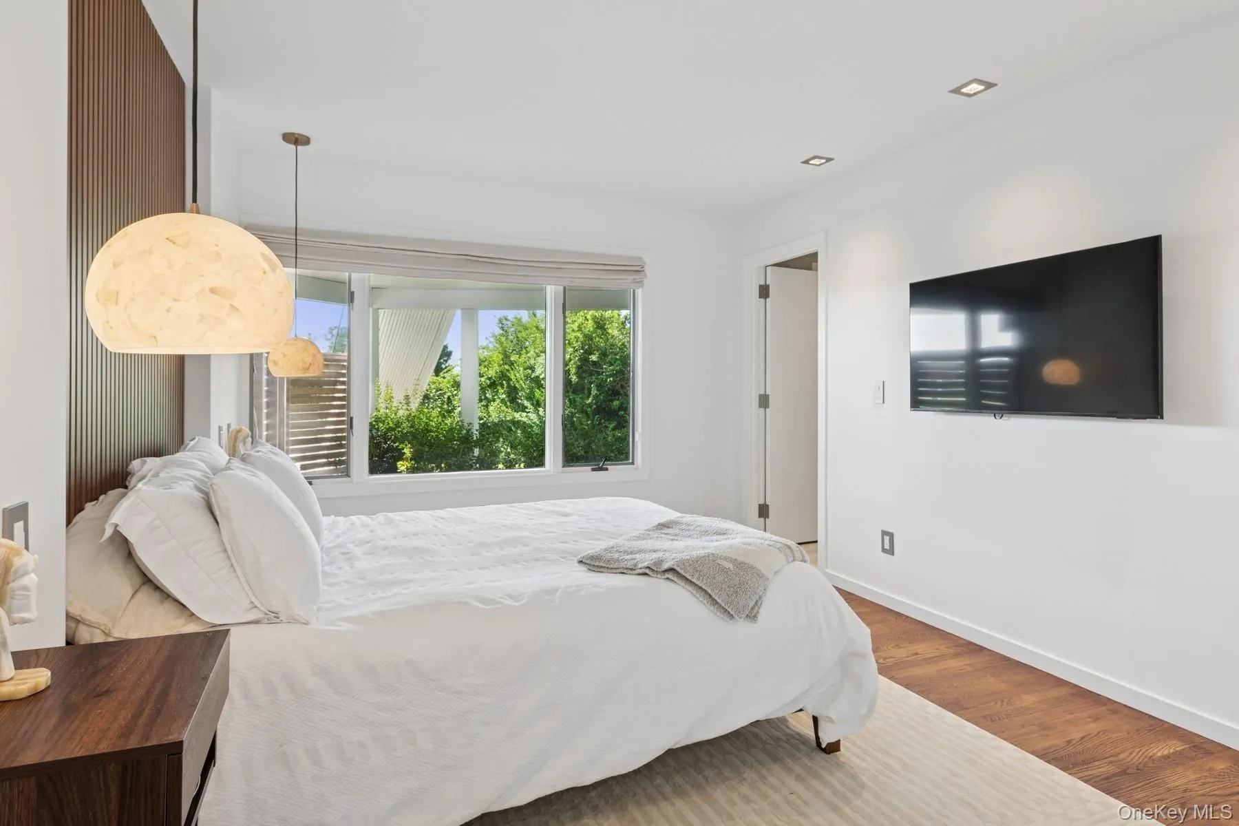 Bedroom featuring wood finished floors and recessed lighting Bedroom featuring wood finished floors and recessed lighting