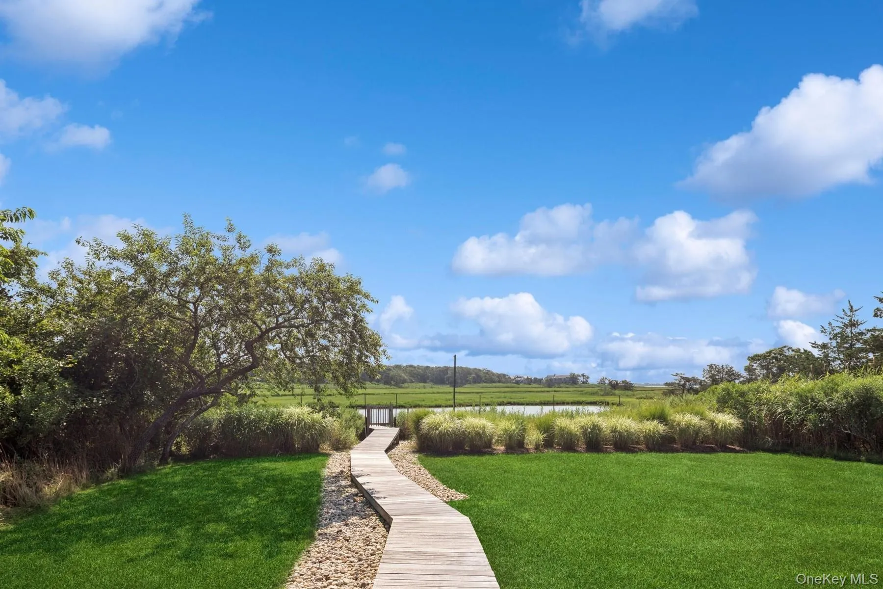 View of grassy yard with a water view View of grassy yard with a water view