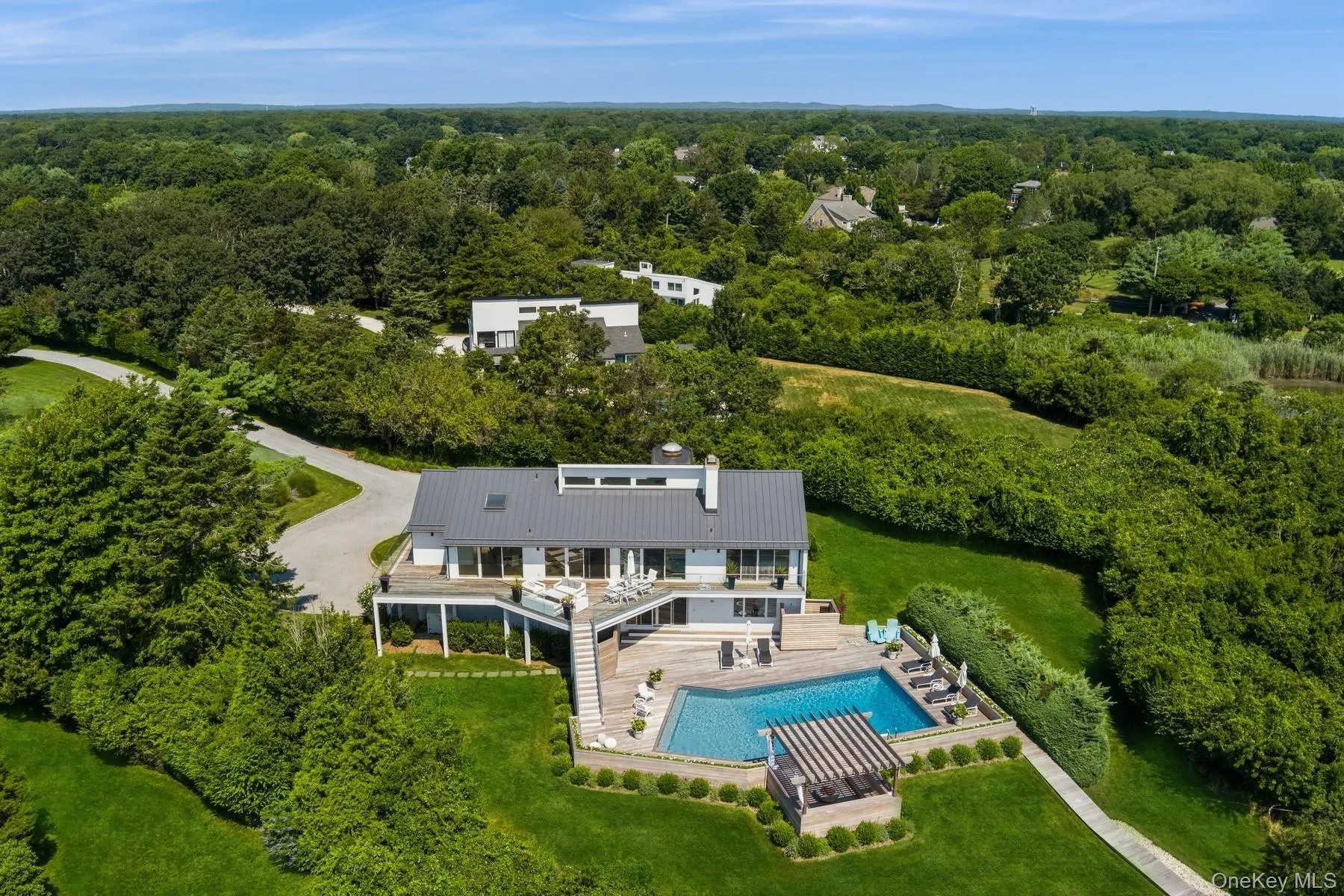 Aerial view of property and surrounding area featuring a heavily wooded area Aerial view of property and surrounding area featuring a heavily wooded area