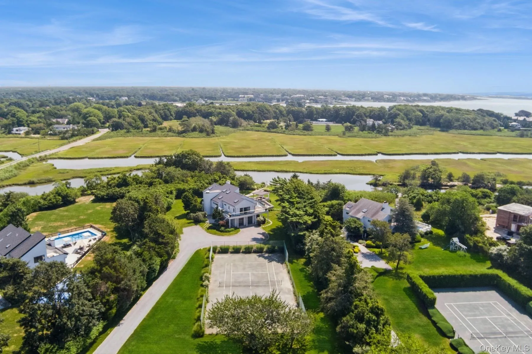 Drone / aerial view of a nearby body of water and a tree filled landscape Drone / aerial view of a nearby body of water and a tree filled landscape