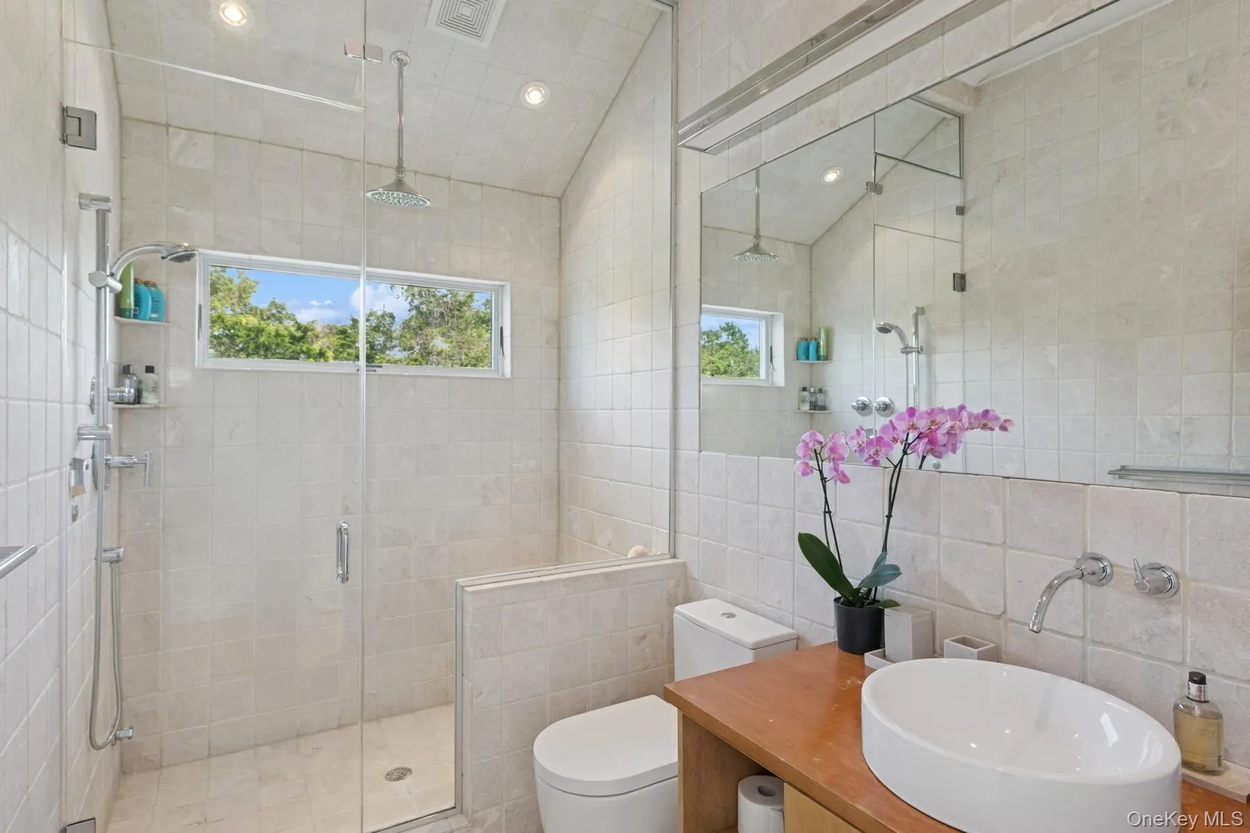 Full bathroom featuring tile walls, a stall shower, vanity, and recessed lighting Full bathroom featuring tile walls, a stall shower, vanity, and recessed lighting