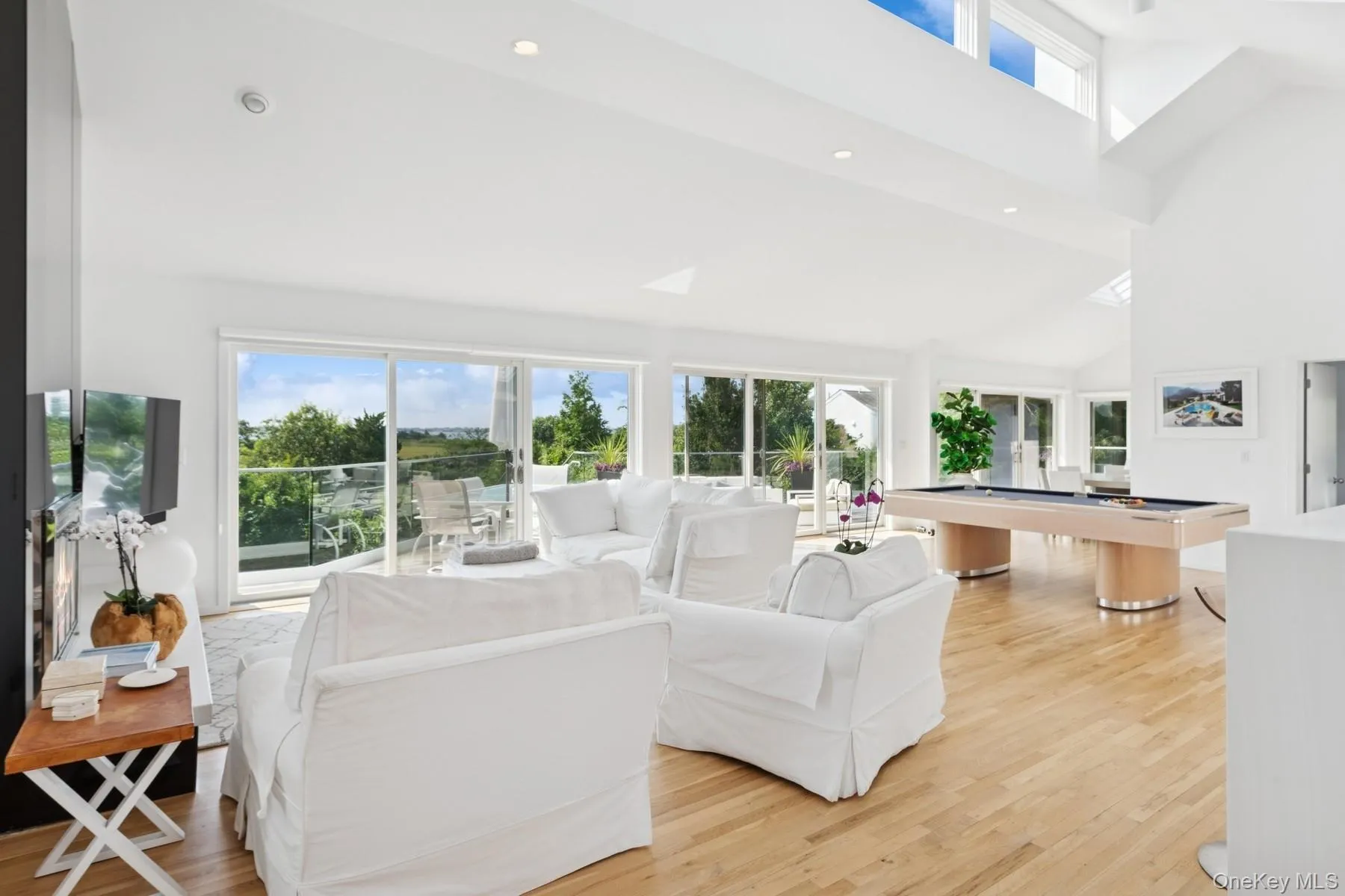 Living area featuring light wood finished floors, billiards table, high vaulted ceiling, and recessed lighting Living area featuring light wood finished floors, billiards table, high vaulted ceiling, and recessed lighting