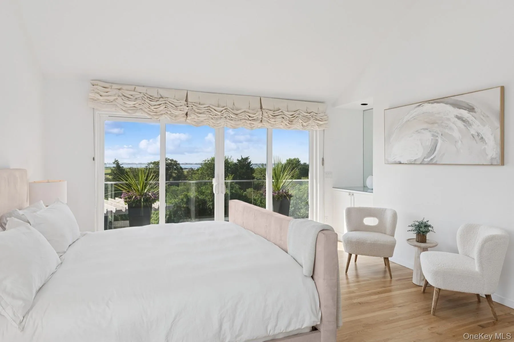 Bedroom featuring vaulted ceiling, light wood-style floors, and access to exterior Bedroom featuring vaulted ceiling, light wood-style floors, and access to exterior