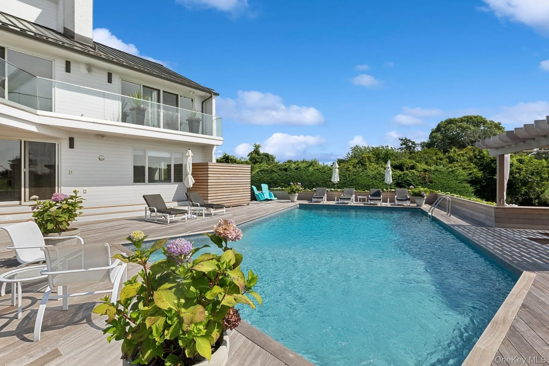Outdoor pool with a deck and a pergola Outdoor pool with a deck and a pergola