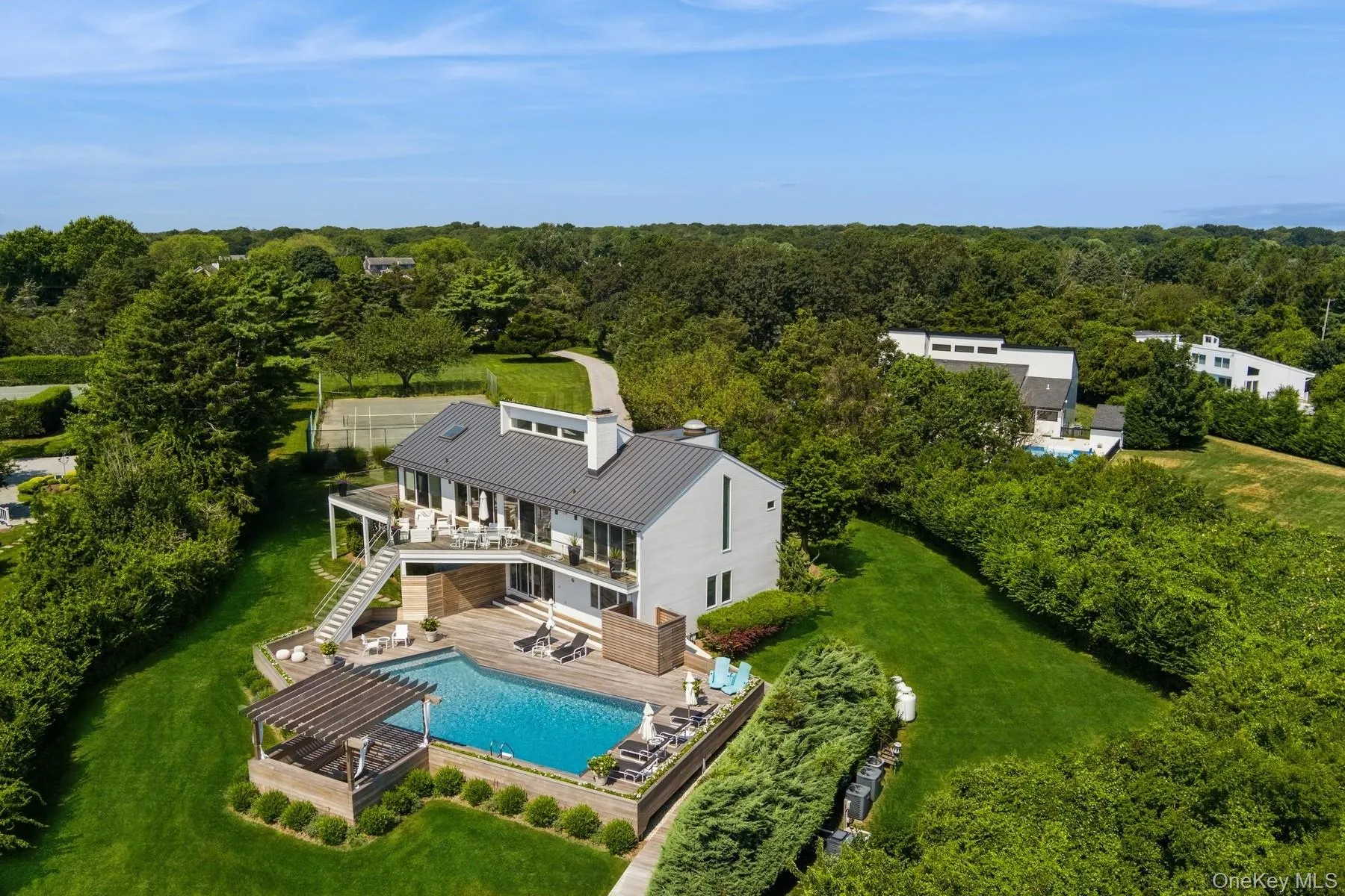 View from above of property with a pool and a heavily wooded area View from above of property with a pool and a heavily wooded area