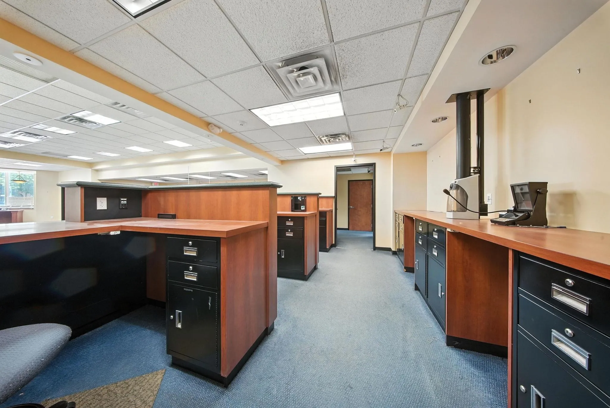 Office area featuring a paneled ceiling and carpet Office area featuring a paneled ceiling and carpet