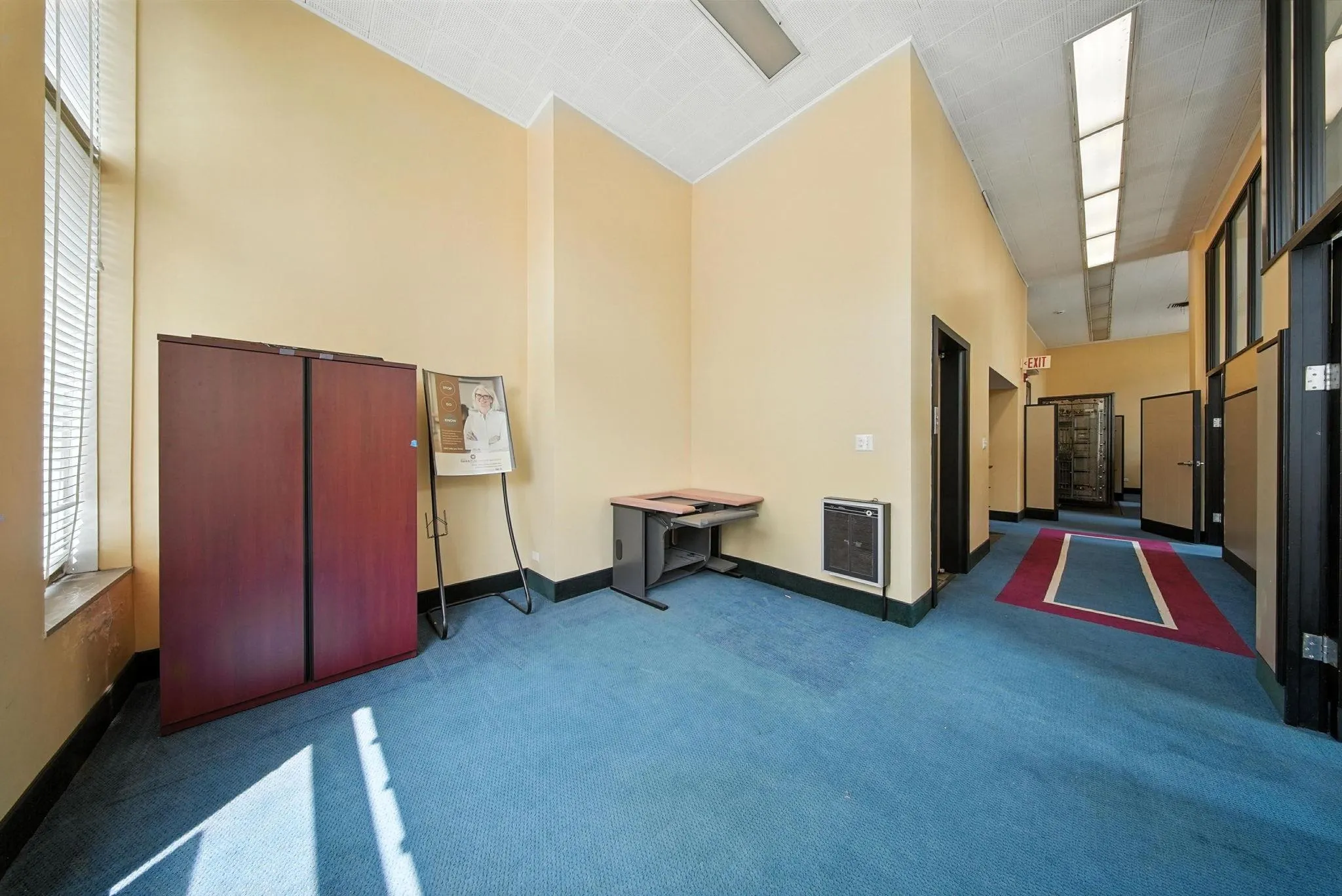 Corridor with high vaulted ceiling and carpet floors Corridor with high vaulted ceiling and carpet floors