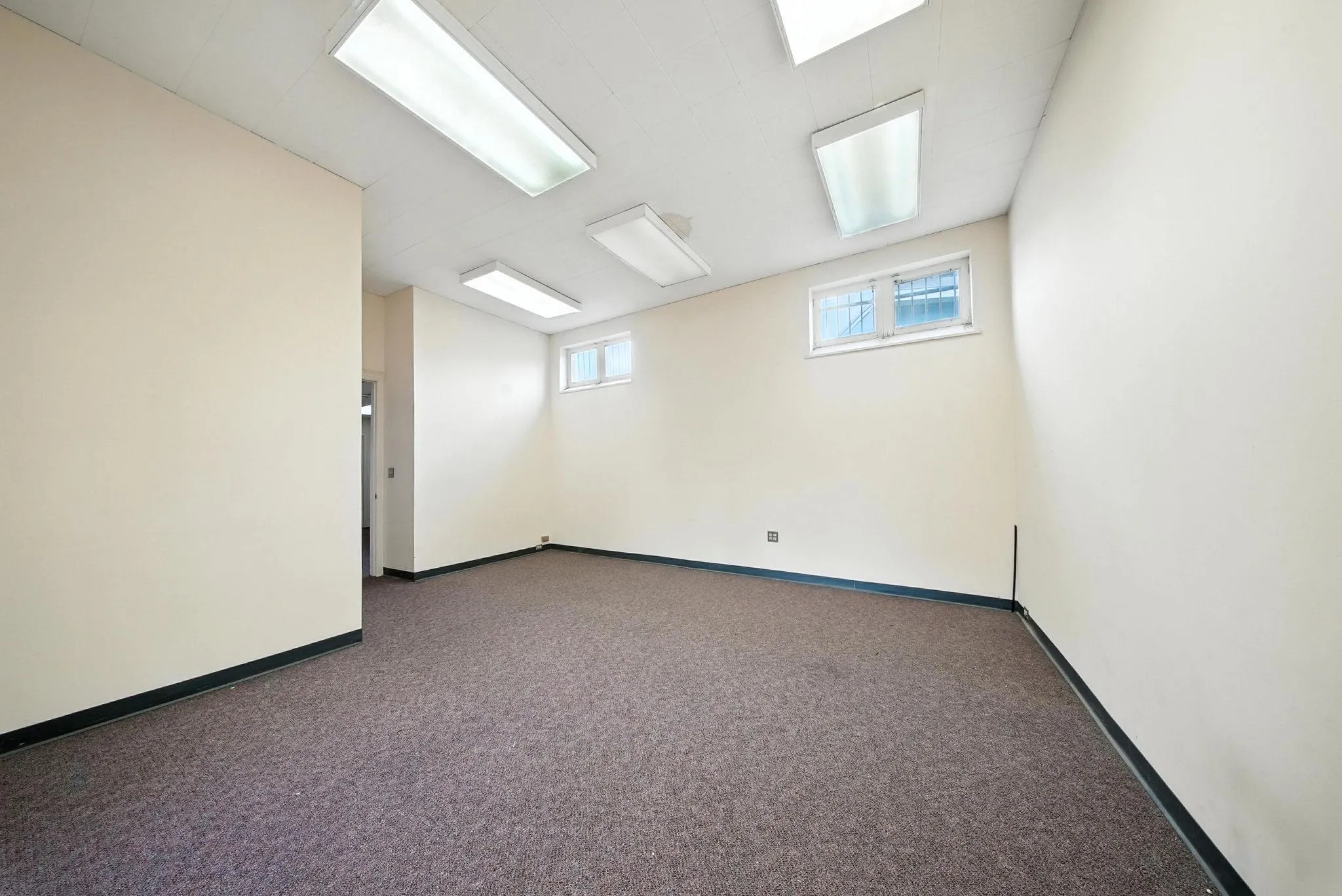 Carpeted spare room with baseboards Carpeted spare room with baseboards