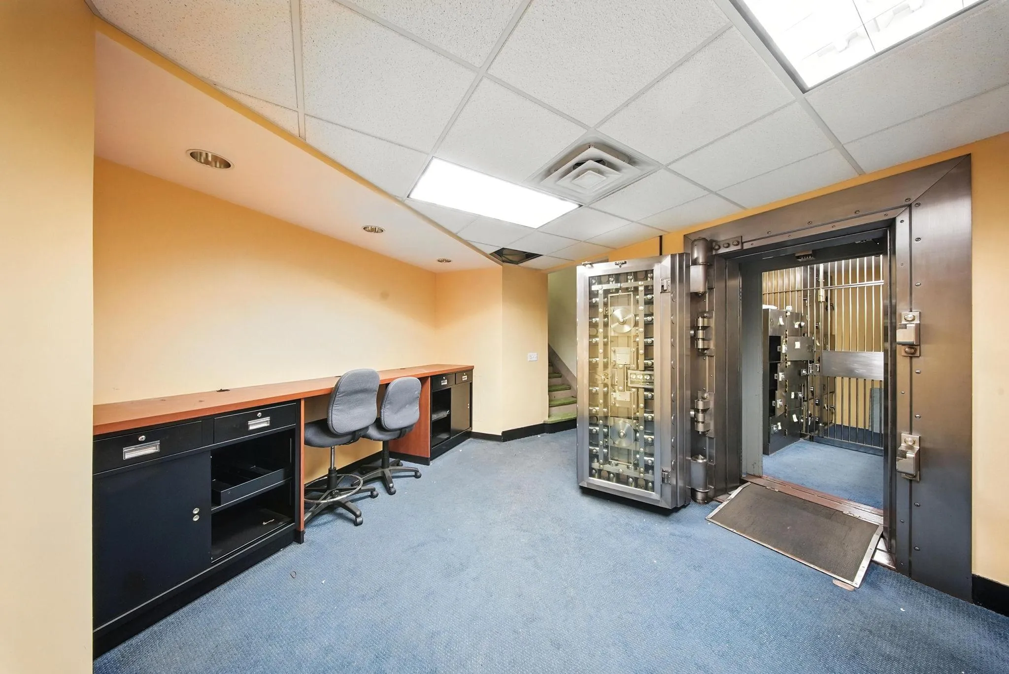 Carpeted home office with a paneled ceiling and baseboards Carpeted home office with a paneled ceiling and baseboards