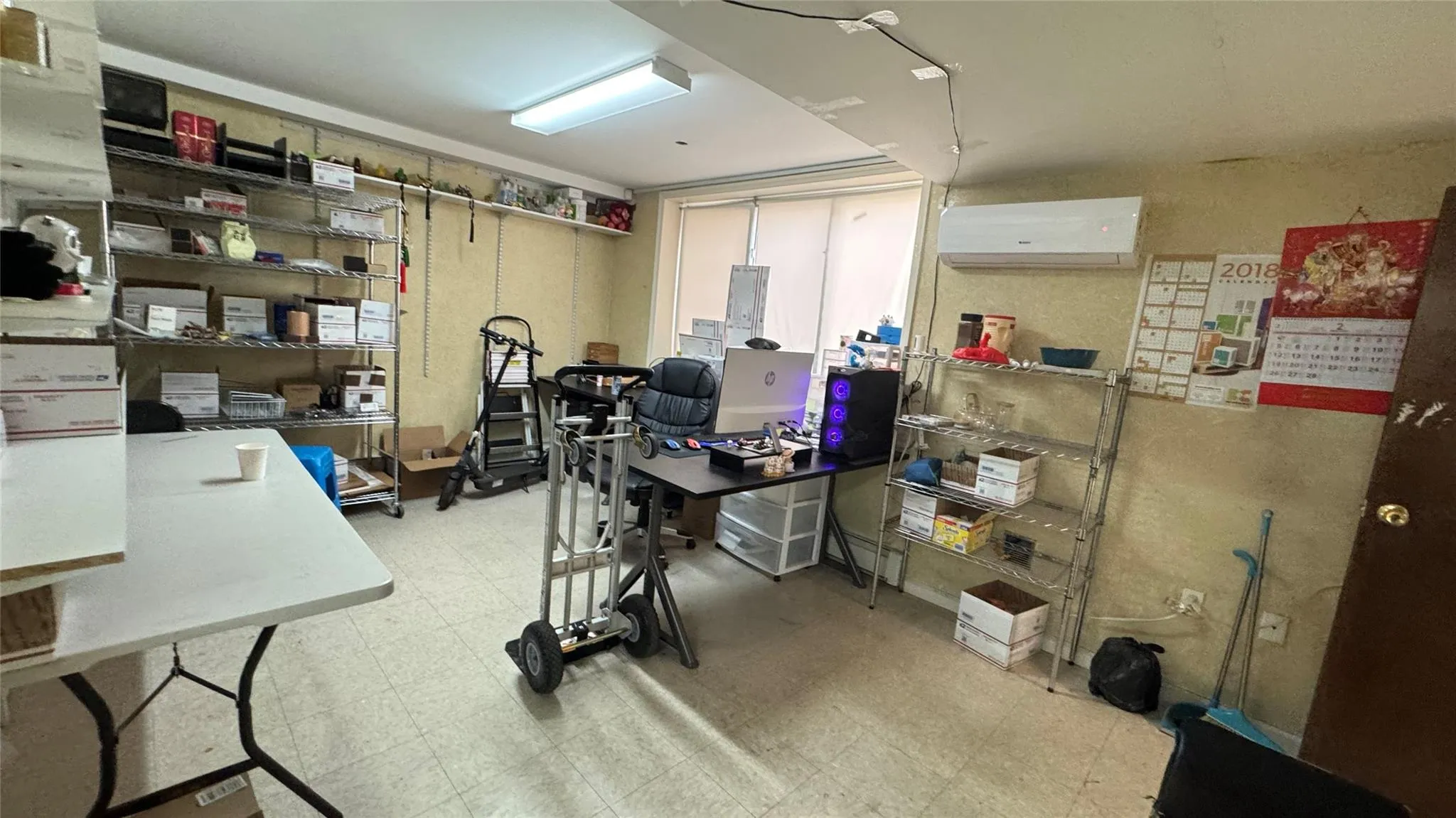 Office area featuring an AC wall unit and tile patterned floors Office area featuring an AC wall unit and tile patterned floors