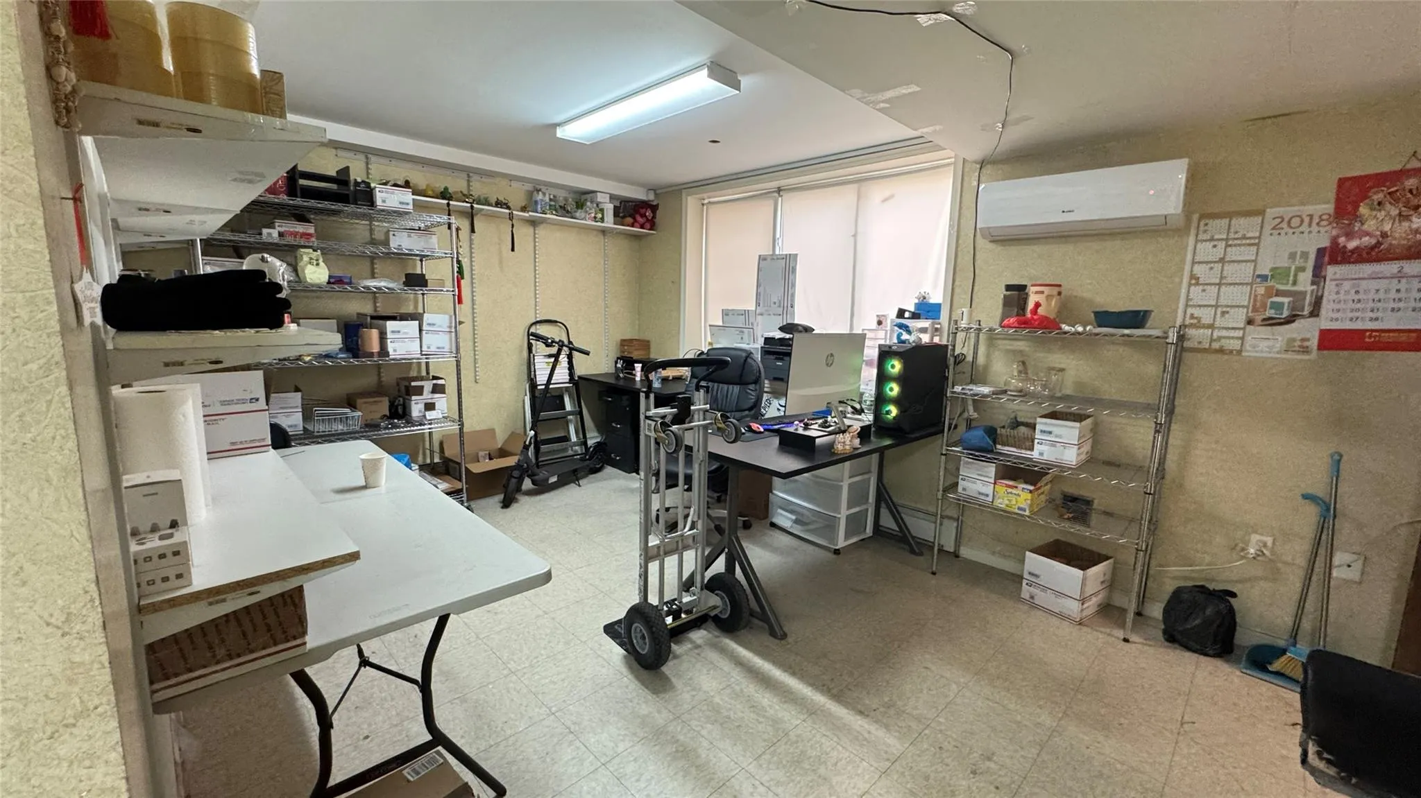 Office featuring tile patterned floors and an AC wall unit Office featuring tile patterned floors and an AC wall unit