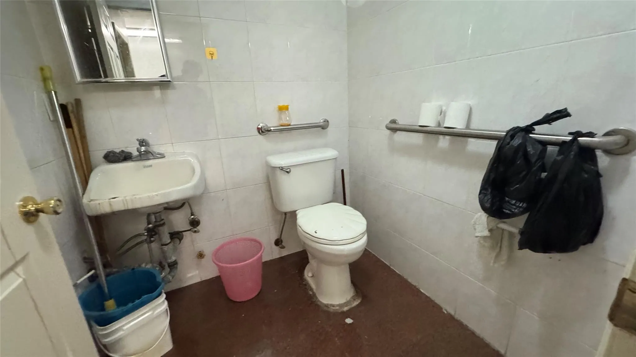Half bath featuring tile walls, toilet, and a sink Half bath featuring tile walls, toilet, and a sink