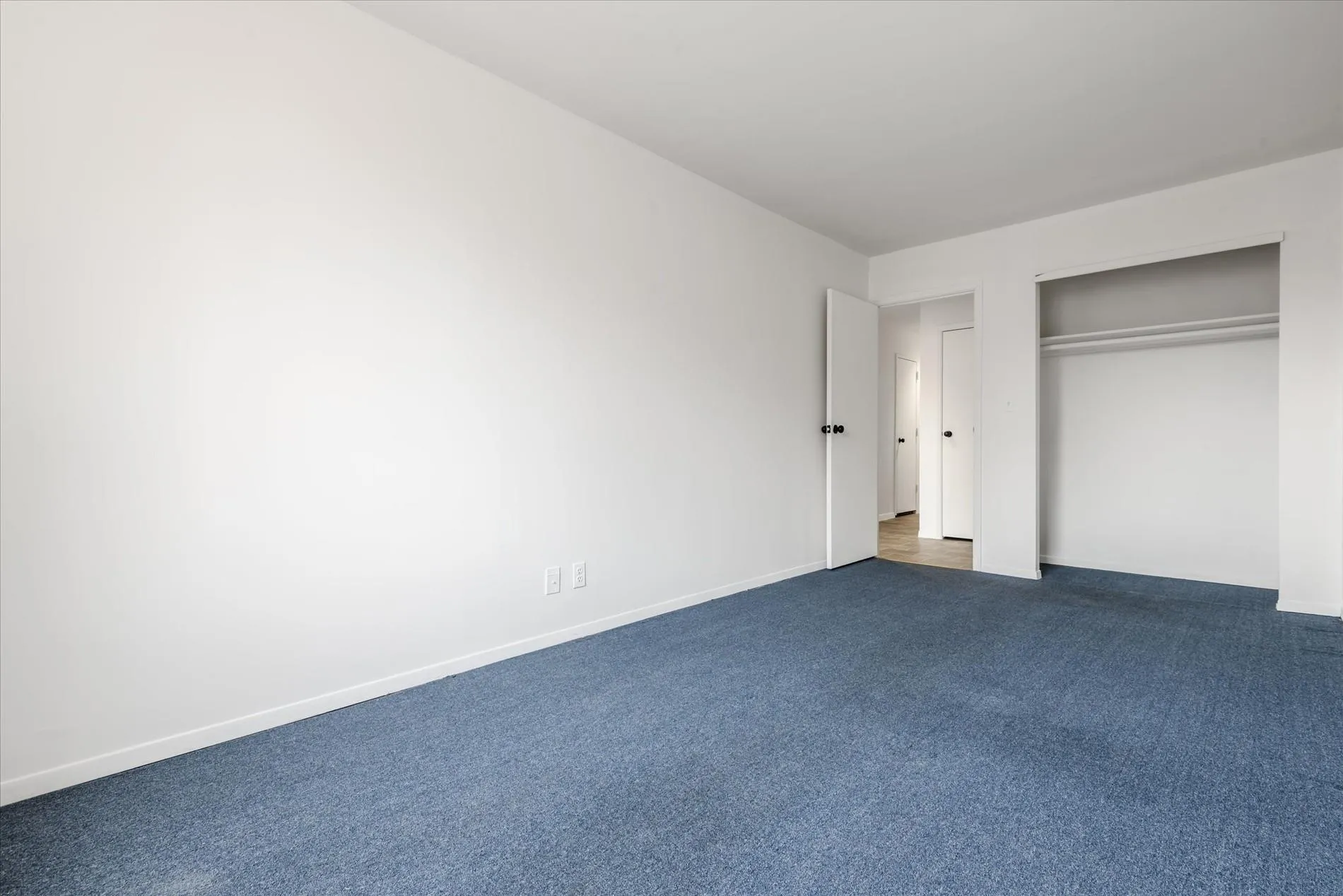 Unfurnished bedroom with carpet and a closet Unfurnished bedroom with carpet and a closet