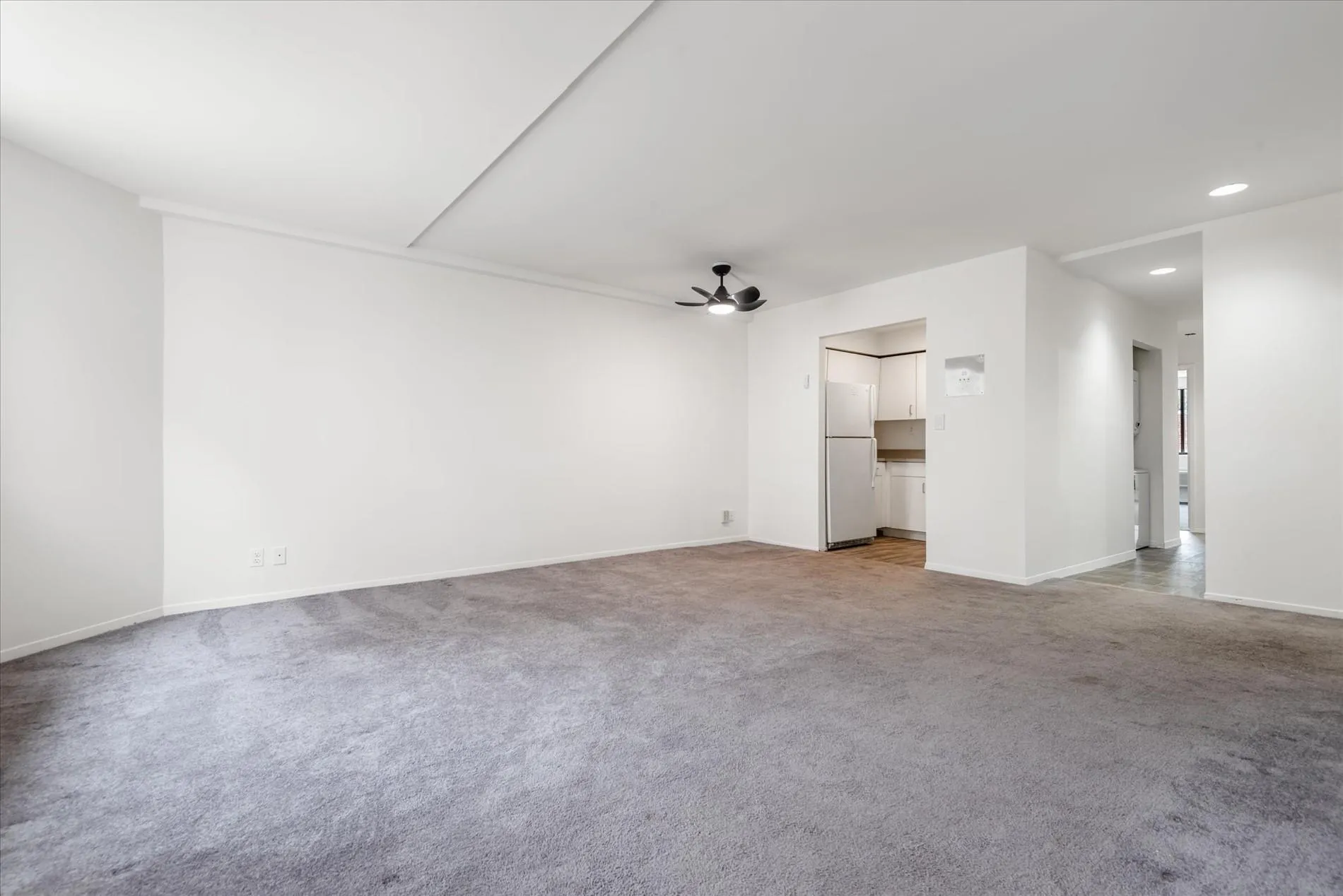 Unfurnished living room featuring carpet, recessed lighting, and a ceiling fan Unfurnished living room featuring carpet, recessed lighting, and a ceiling fan