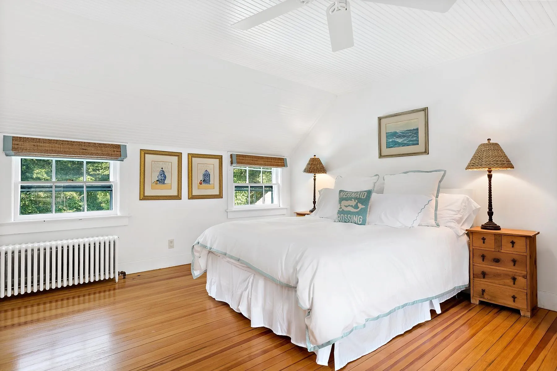 Bedroom featuring radiator heating unit, wood-type flooring, lofted ceiling, and ceiling fan Bedroom featuring radiator heating unit, wood-type flooring, lofted ceiling, and ceiling fan