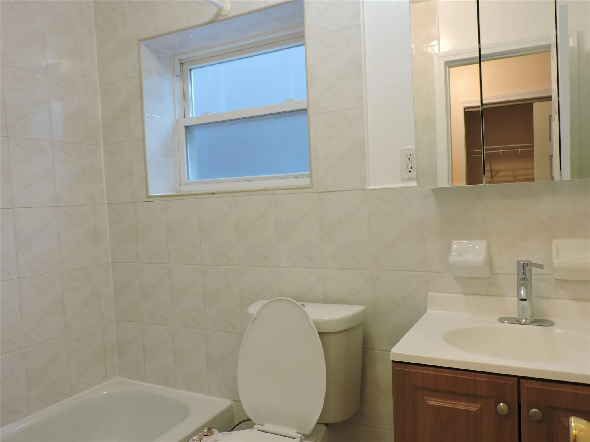 Bathroom featuring vanity and tile walls Bathroom featuring vanity and tile walls