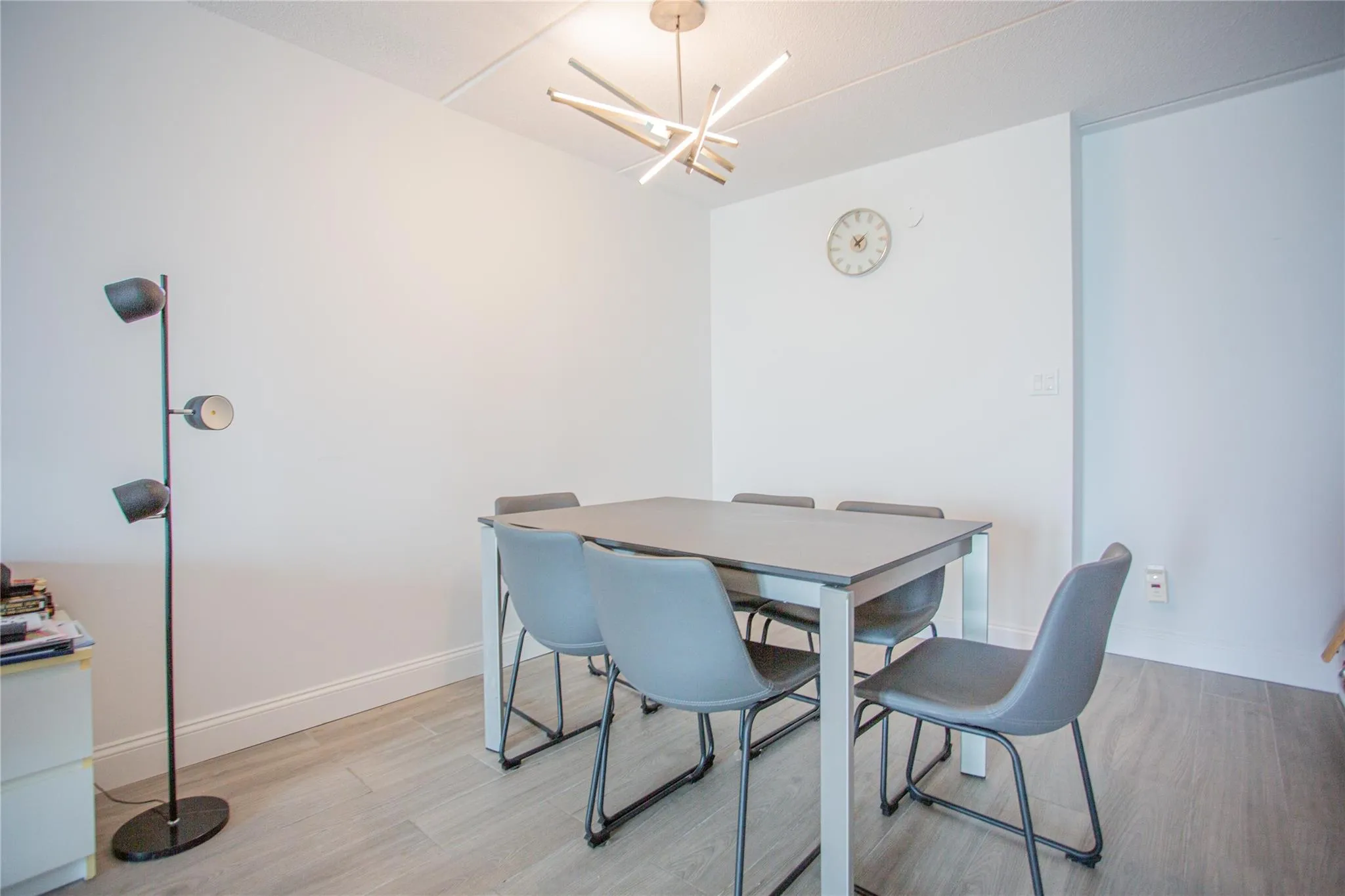 Dining space featuring light wood-style floors and a chandelier Dining space featuring light wood-style floors and a chandelier