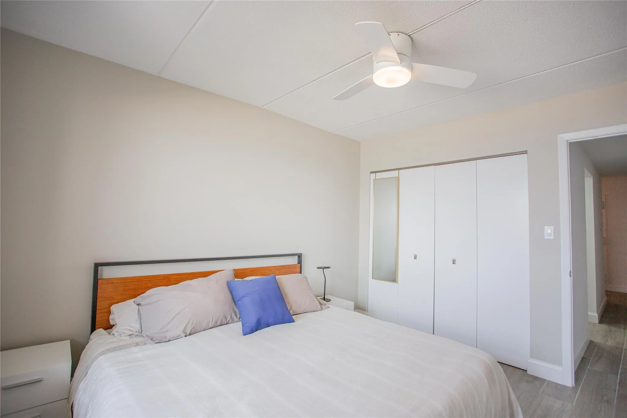 Bedroom featuring light wood-style flooring, a closet, and a ceiling fan Bedroom featuring light wood-style flooring, a closet, and a ceiling fan