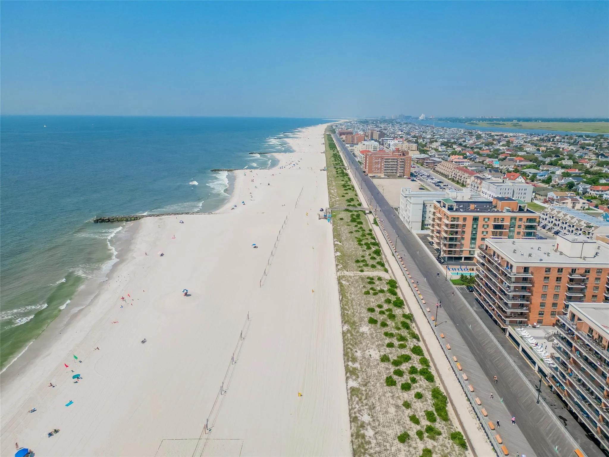 View of urban area featuring waterfront with a beach View of urban area featuring waterfront with a beach