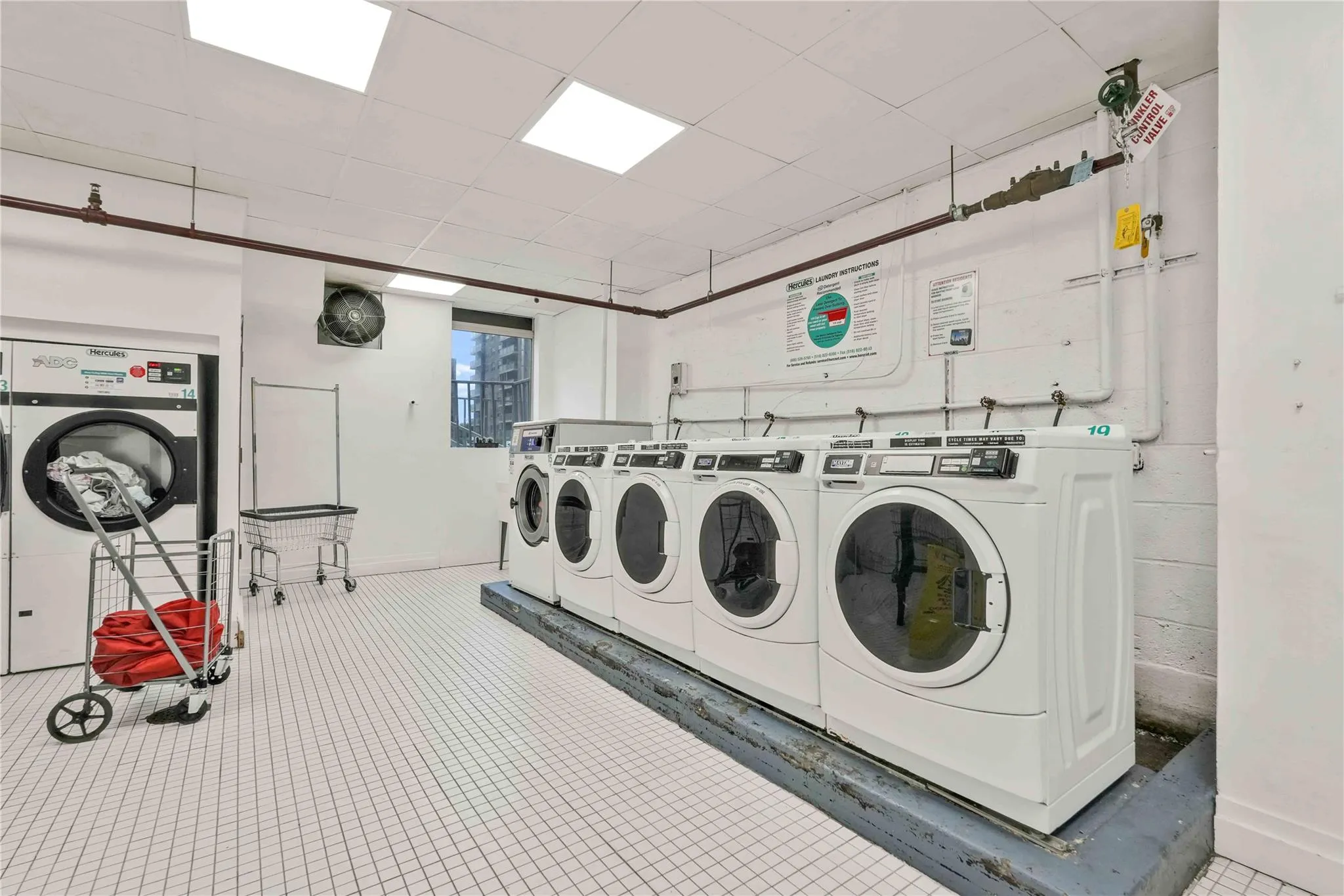 Shared laundry room featuring separate washer and dryer and baseboards Shared laundry room featuring separate washer and dryer and baseboards