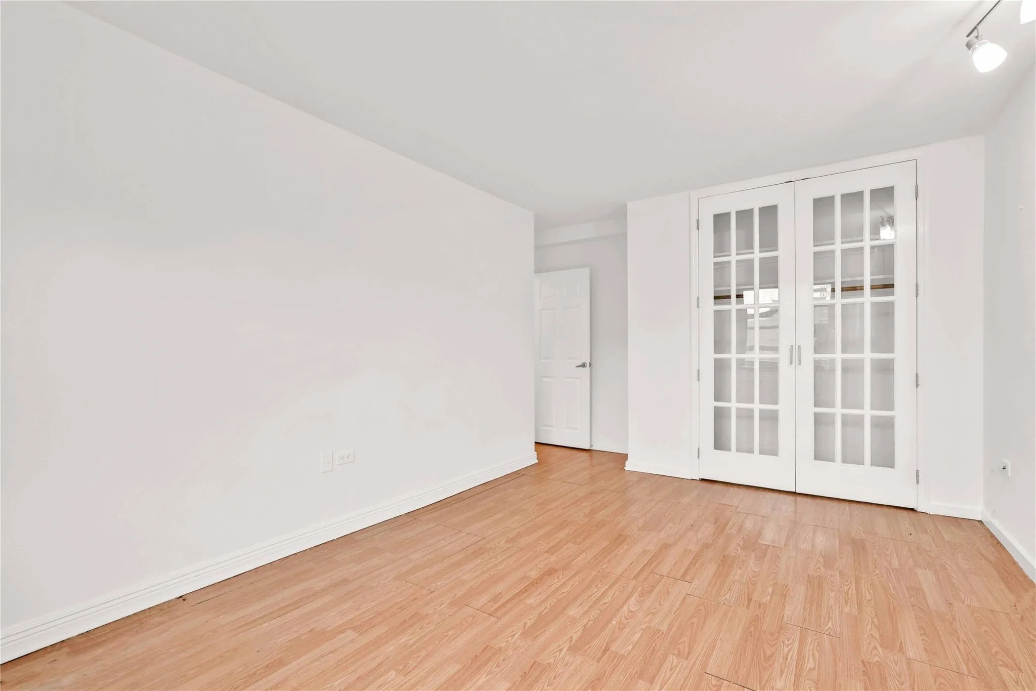 Spare room with baseboards and wood finished floors Spare room with baseboards and wood finished floors