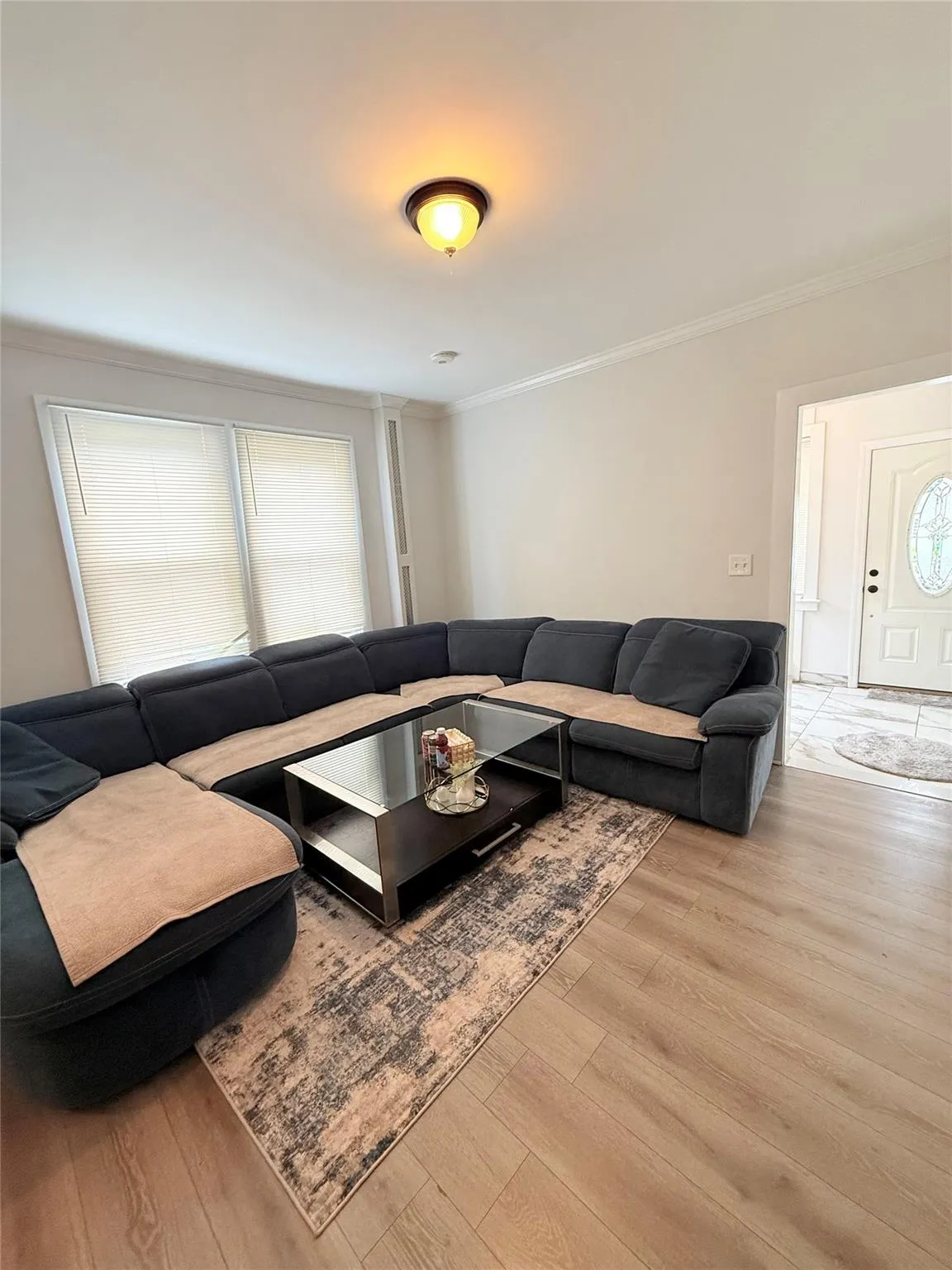 Living area with wood finished floors and ornamental molding Living area with wood finished floors and ornamental molding