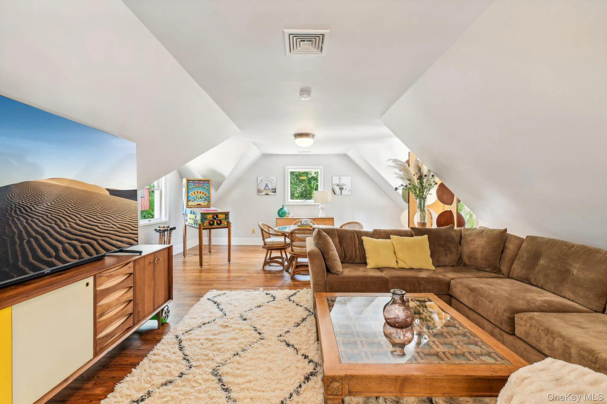 Living room with wood finished floors and vaulted ceiling Living room with wood finished floors and vaulted ceiling