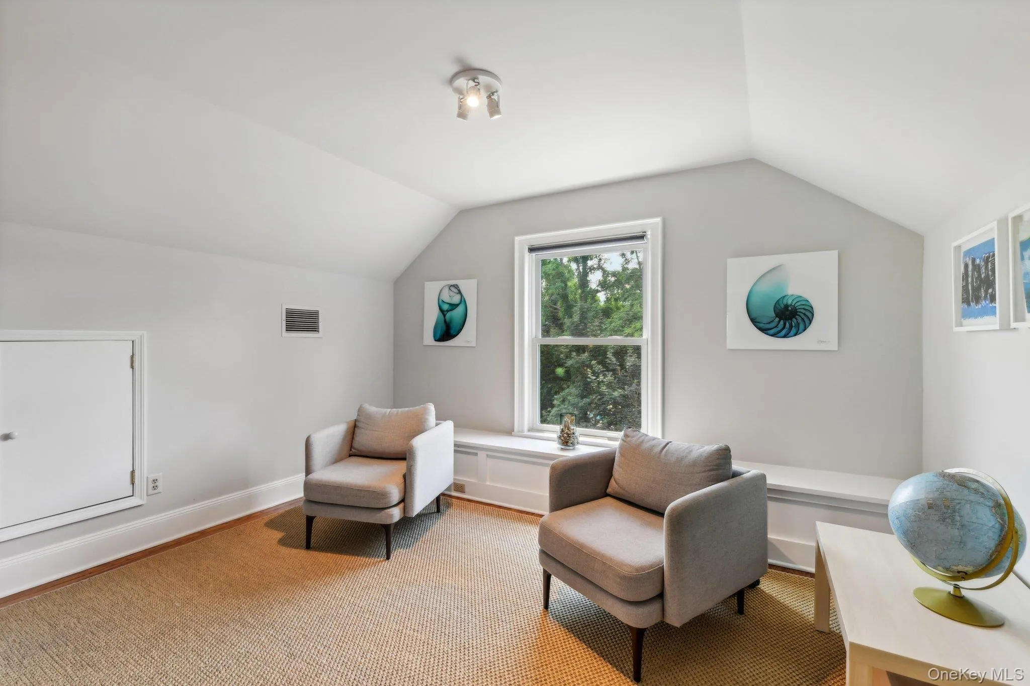 Sitting room with lofted ceiling and baseboards Sitting room with lofted ceiling and baseboards