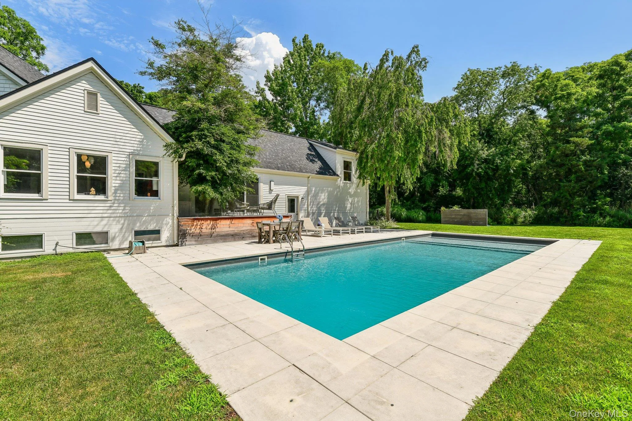 Outdoor pool with a patio and a yard Outdoor pool with a patio and a yard