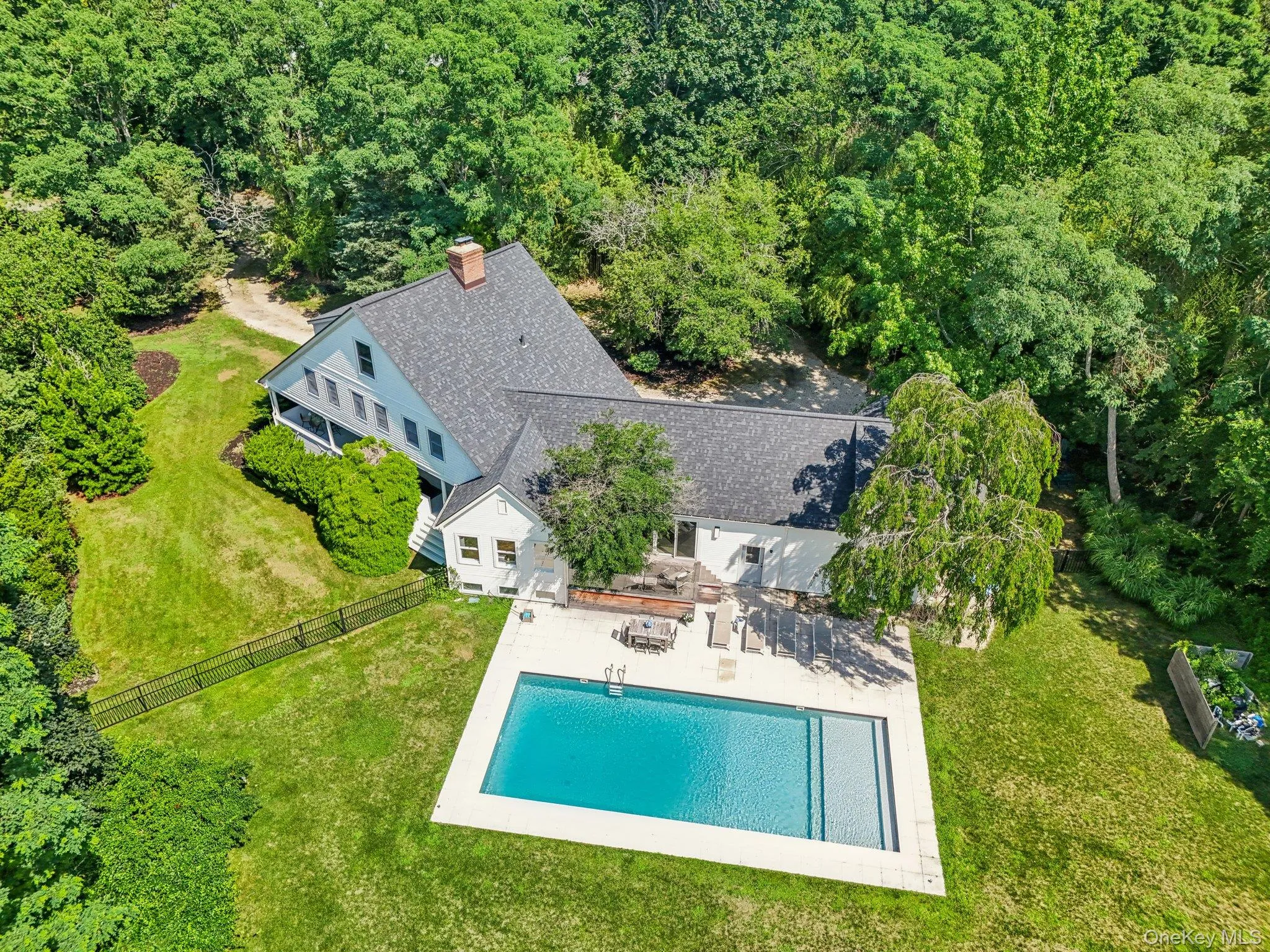 View of subject property featuring a pool area and a heavily wooded area View of subject property featuring a pool area and a heavily wooded area