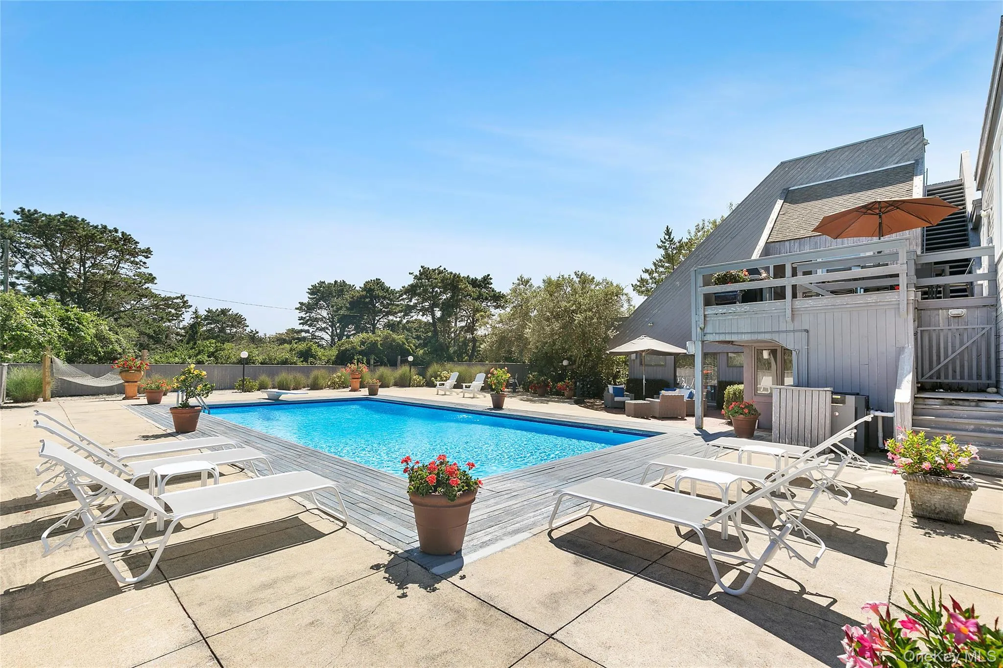 View of swimming pool featuring a patio, an outdoor hangout area, and a diving board View of swimming pool featuring a patio, an outdoor hangout area, and a diving board