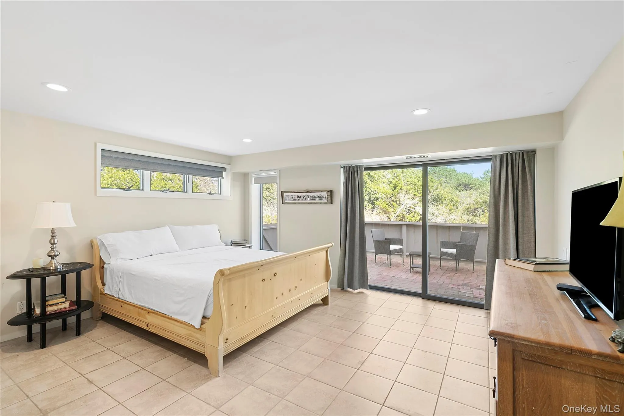 Bedroom with light tile patterned flooring, access to exterior, and recessed lighting Bedroom with light tile patterned flooring, access to exterior, and recessed lighting